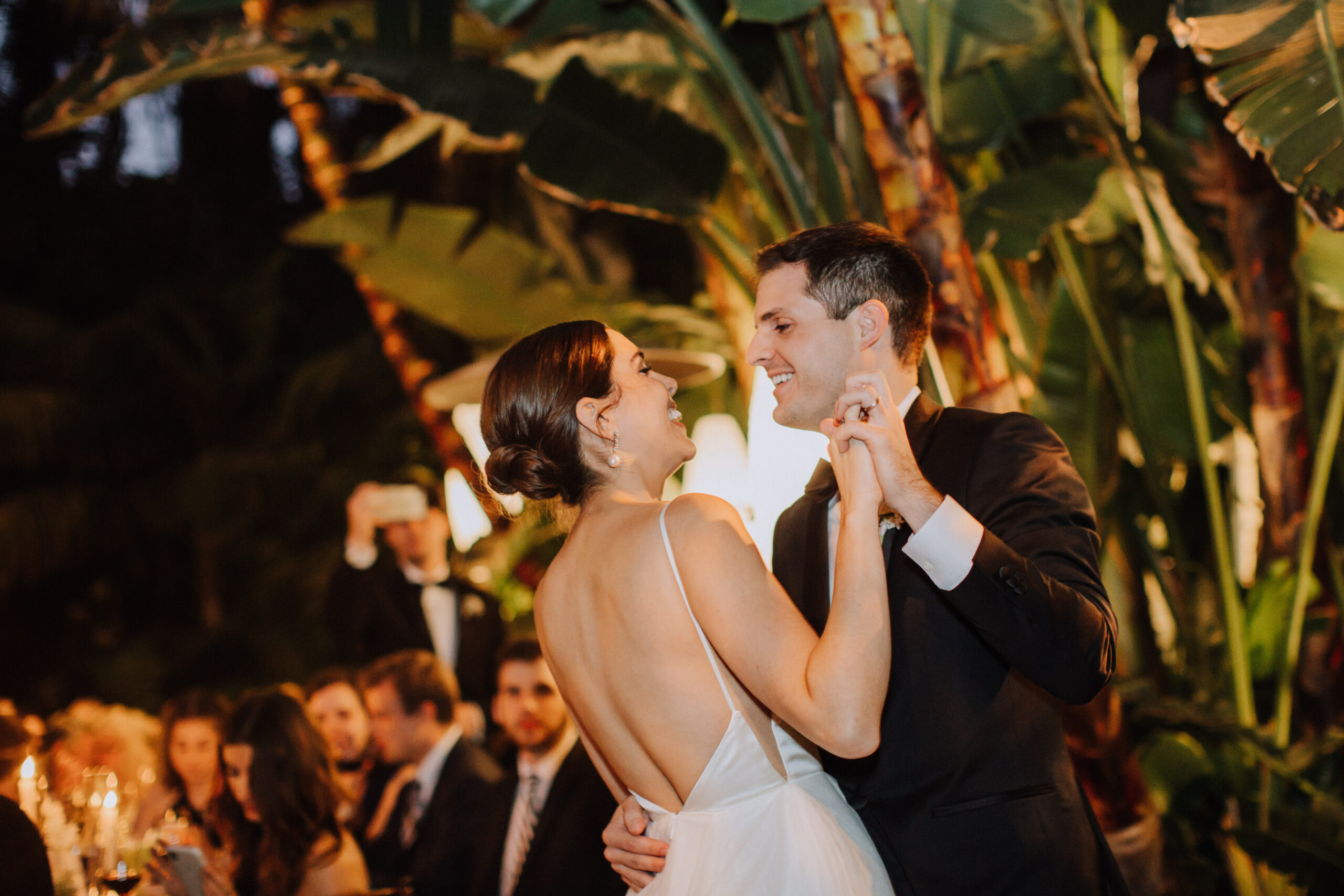 beautiful bride and groom share their first dance together during their Tropical Los Angeles Backyard Wedding