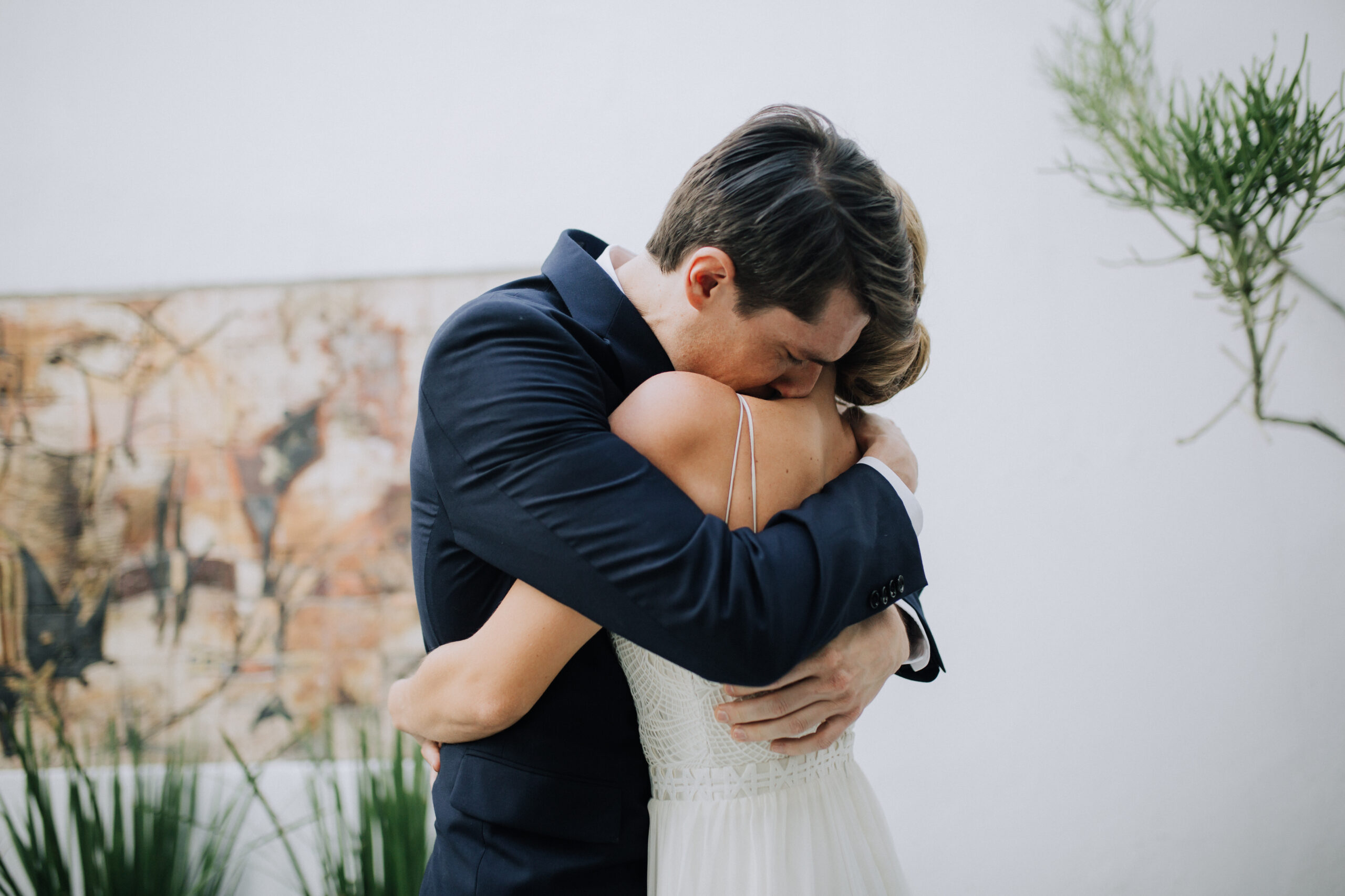 groom sheds a tear with his bride at their first look photoshoot