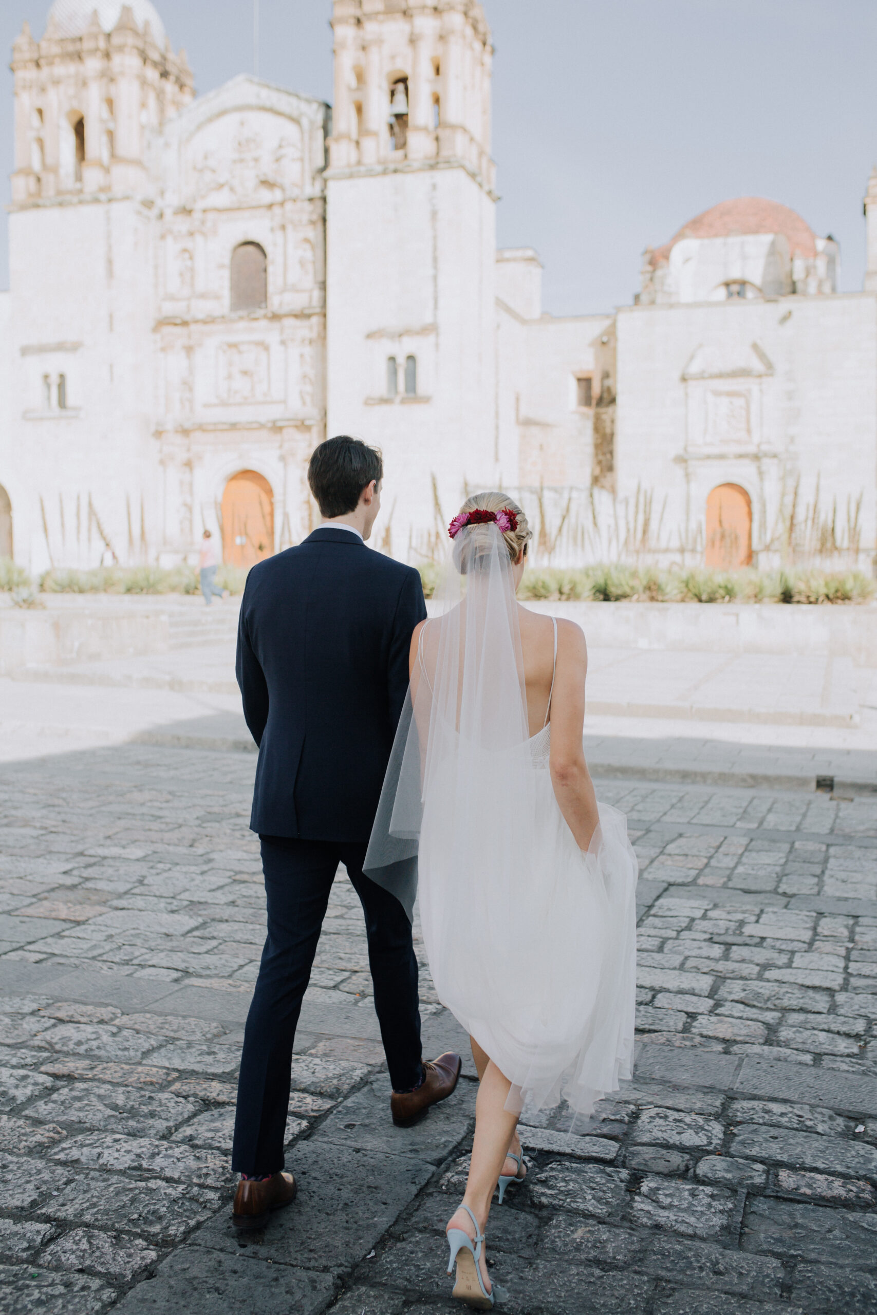 Stunning bride and groom pose in front of a stunning church after their stunning Oaxaca Wedding 