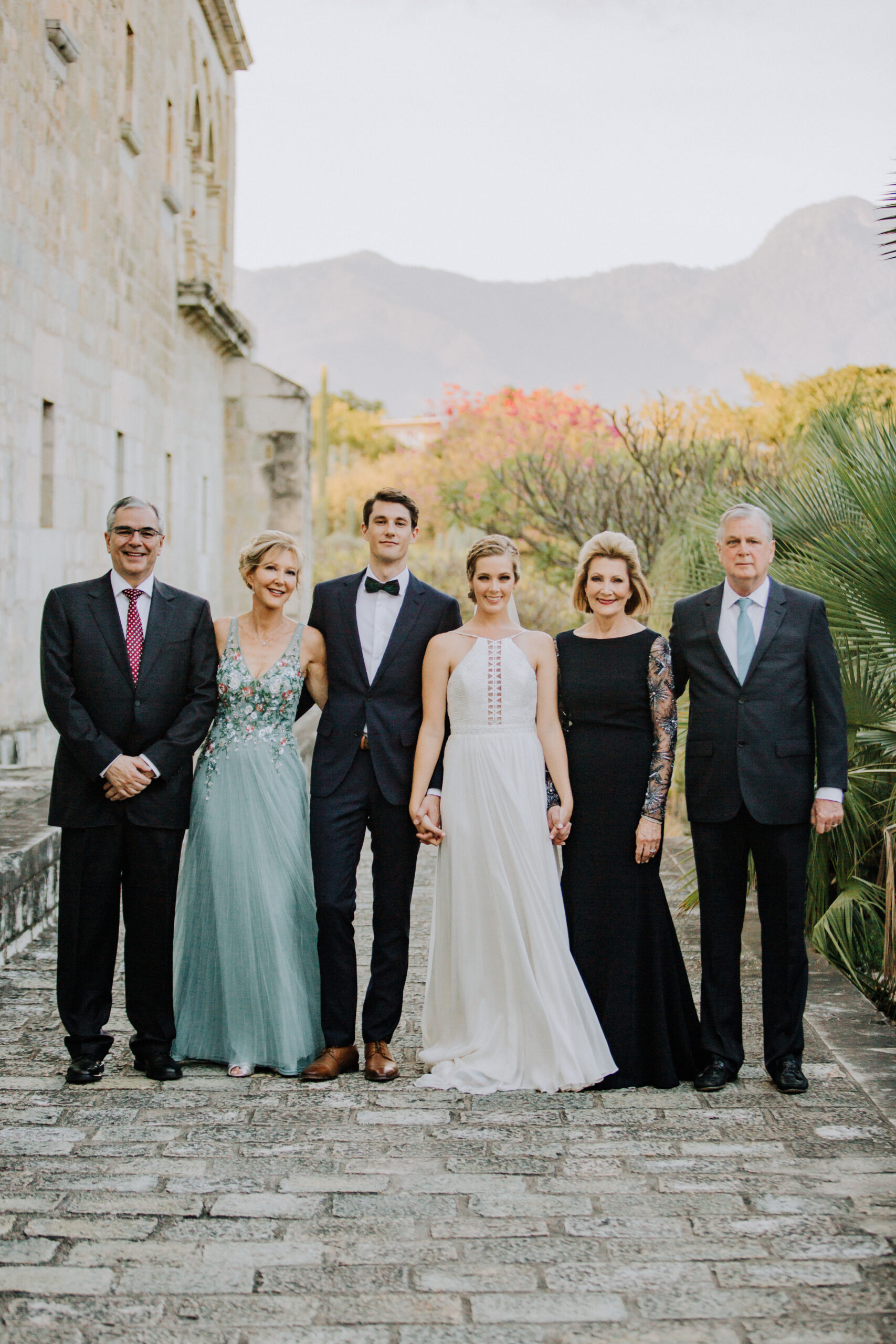 Bride and grooms family stands outside the stunning church wedding venue 