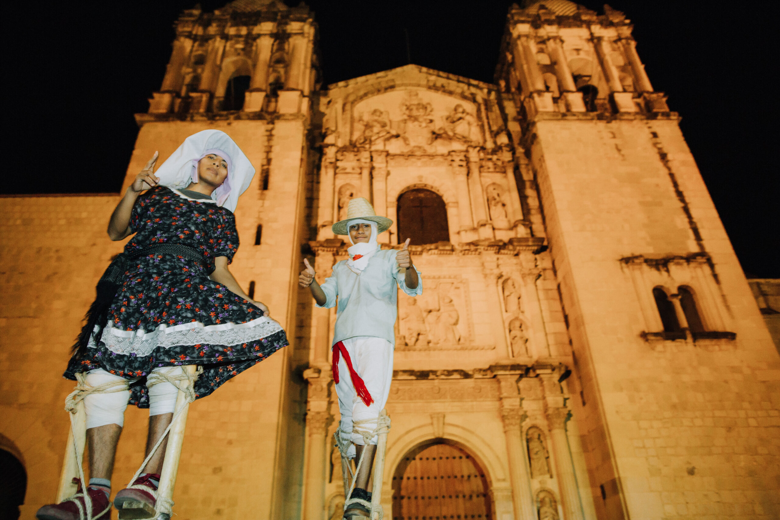 stiltwalkers pose in front of the stunning church venue