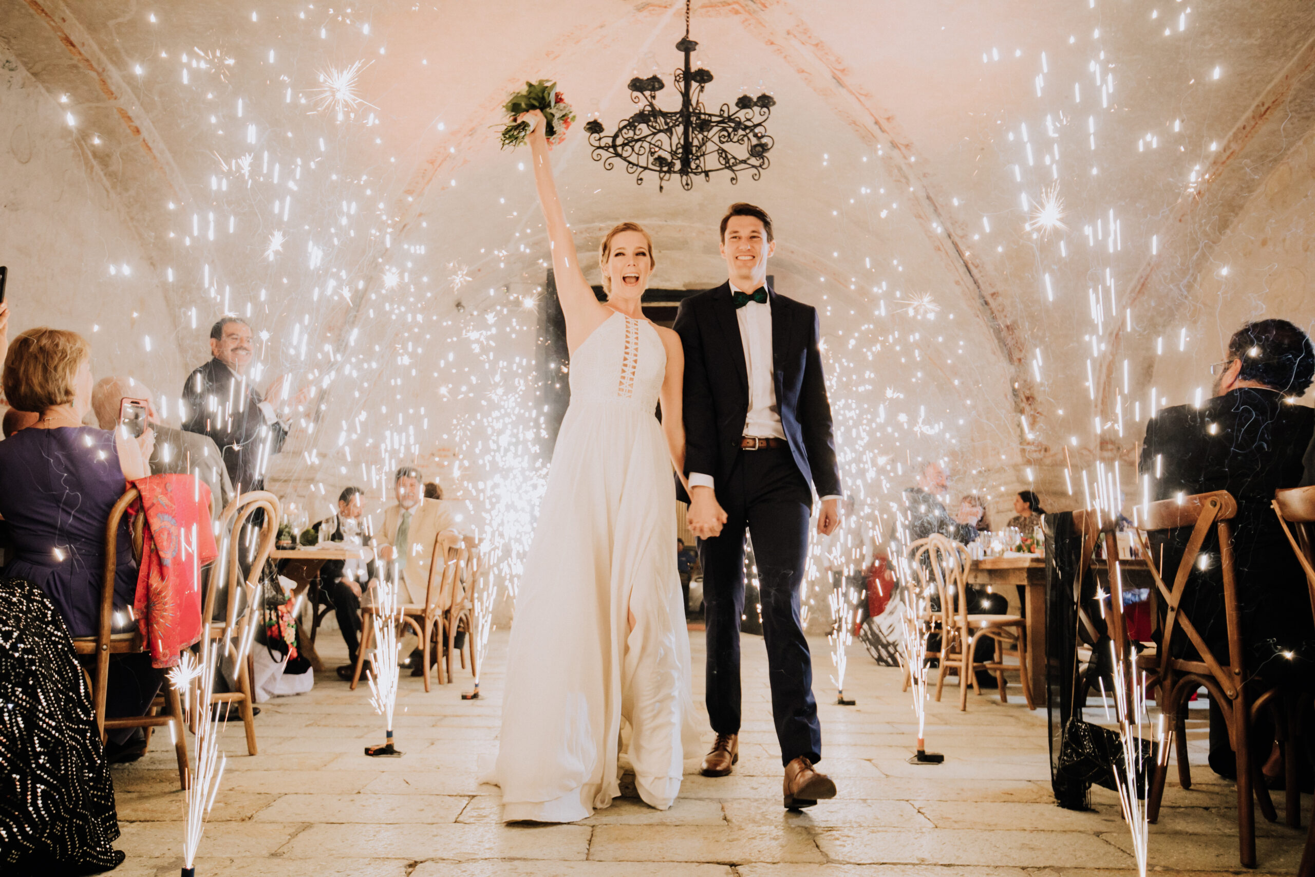 bride and groom exit their reception with sparklers