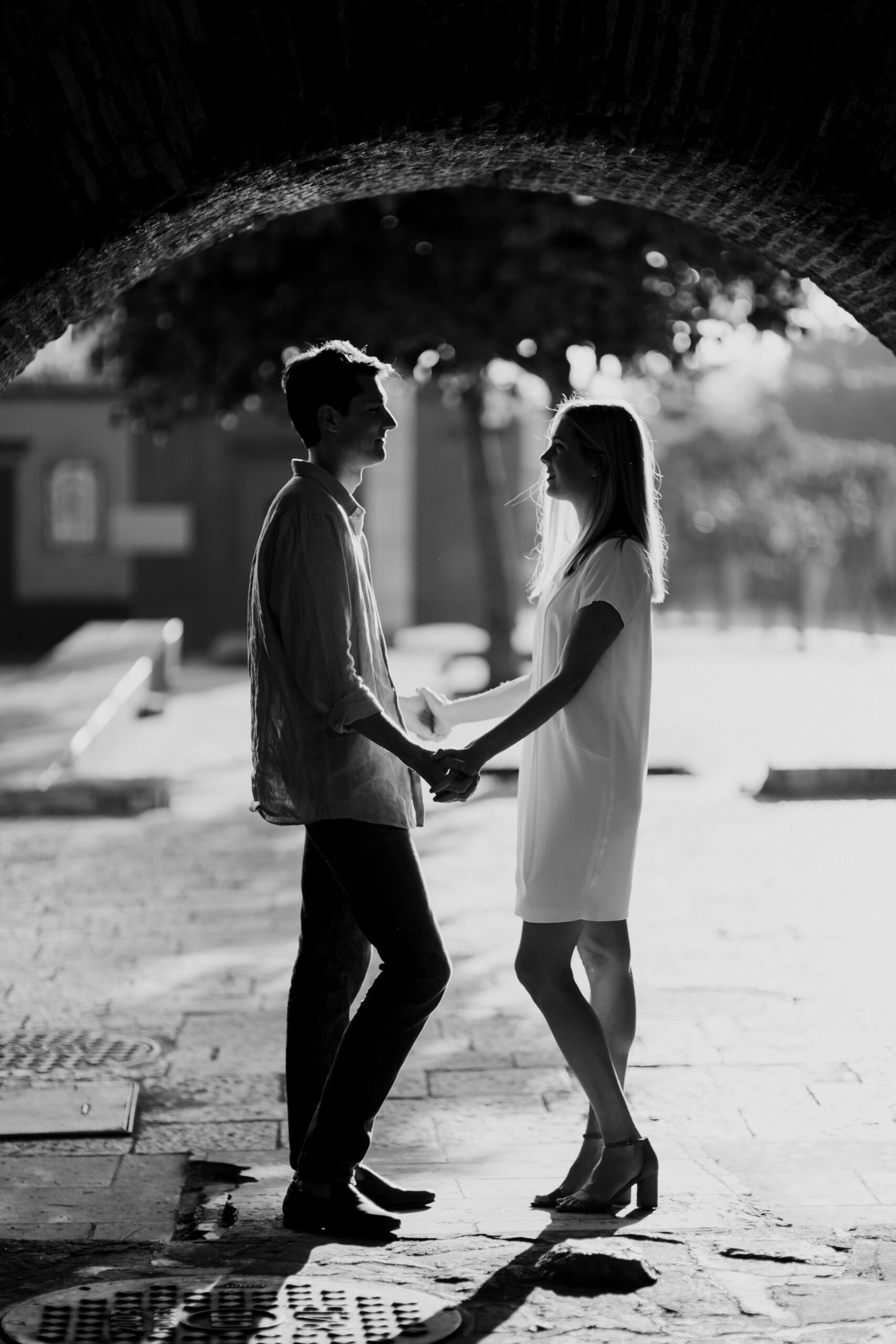 beautiful couple pose holding hands in a tunnel