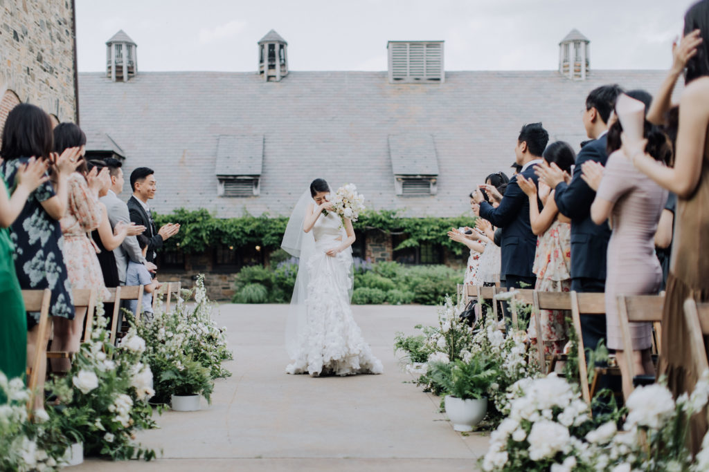 Bicultural elegant wedding with bride walking down the aisle