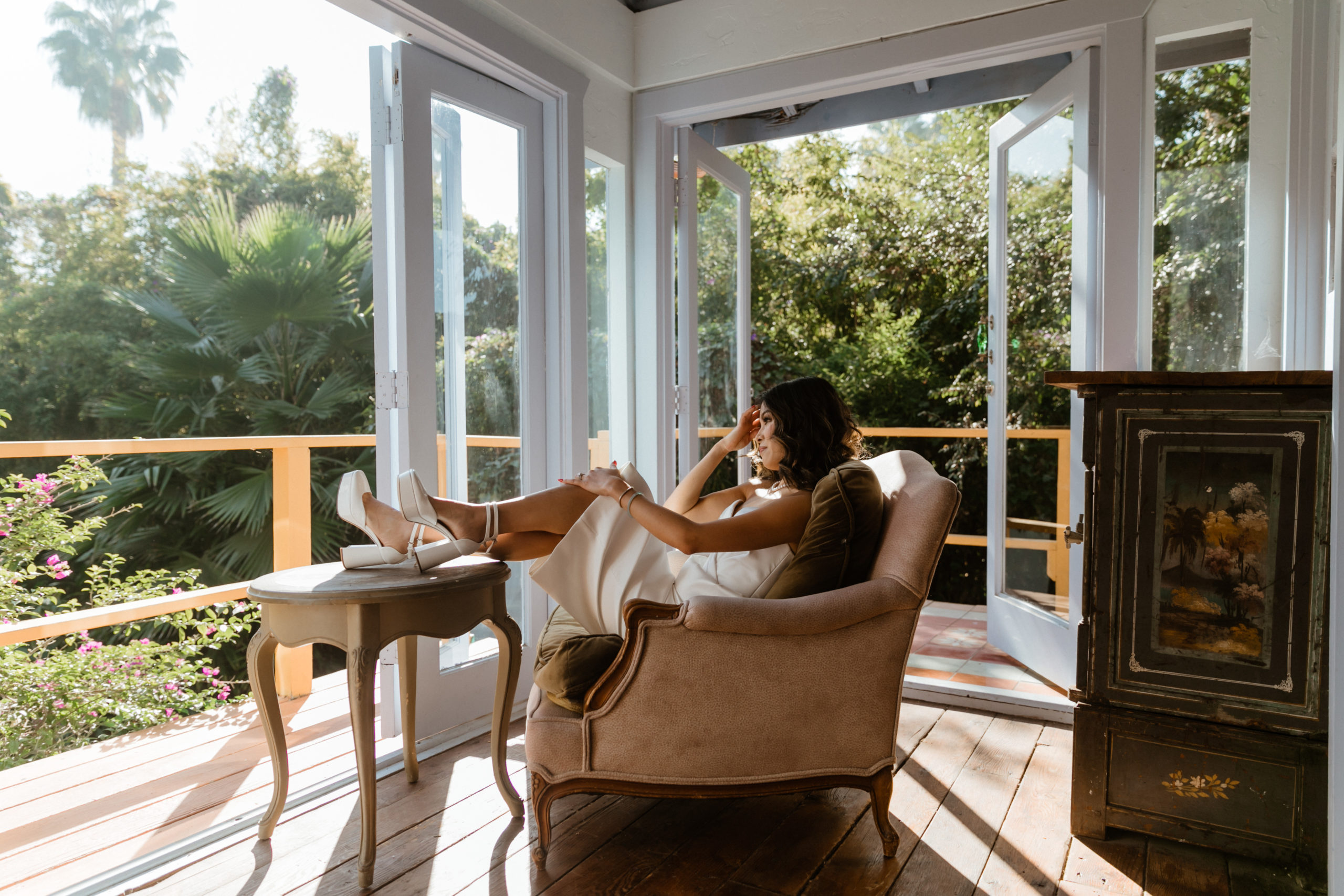 bride poses in the sunroom of her stunning LA home