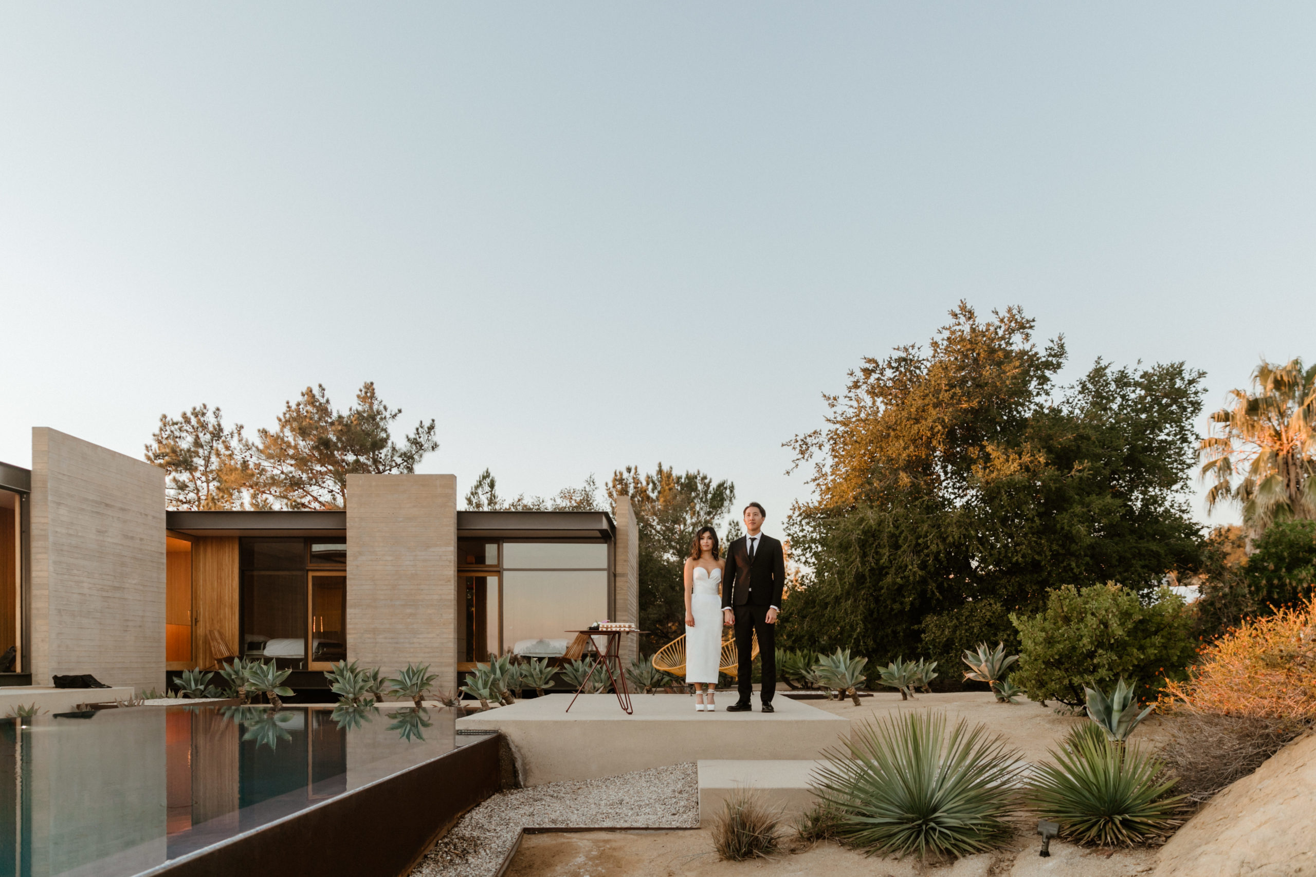 bride and groom pose outside their stunning LA home