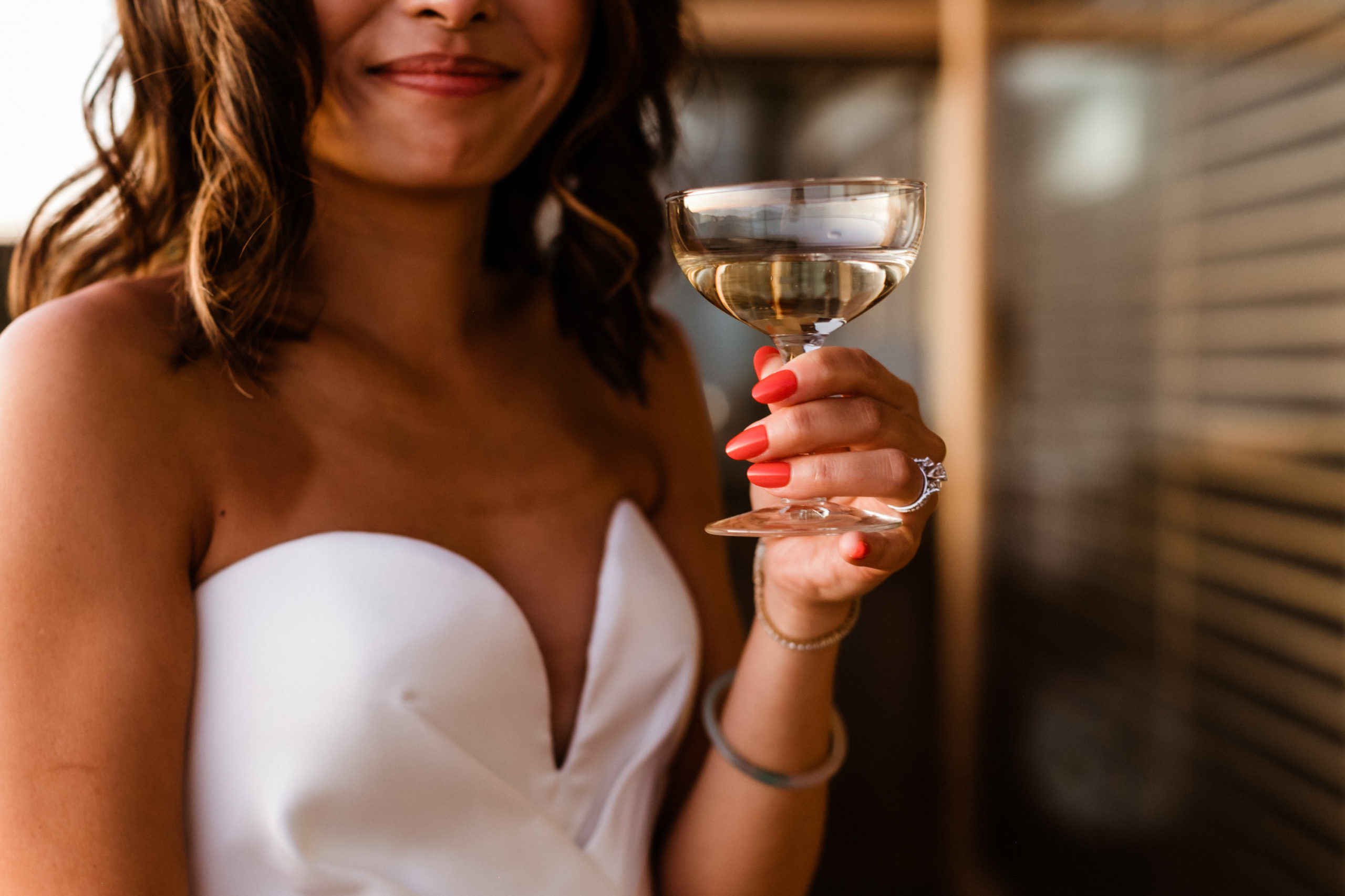 bride poses with her drink in her hand