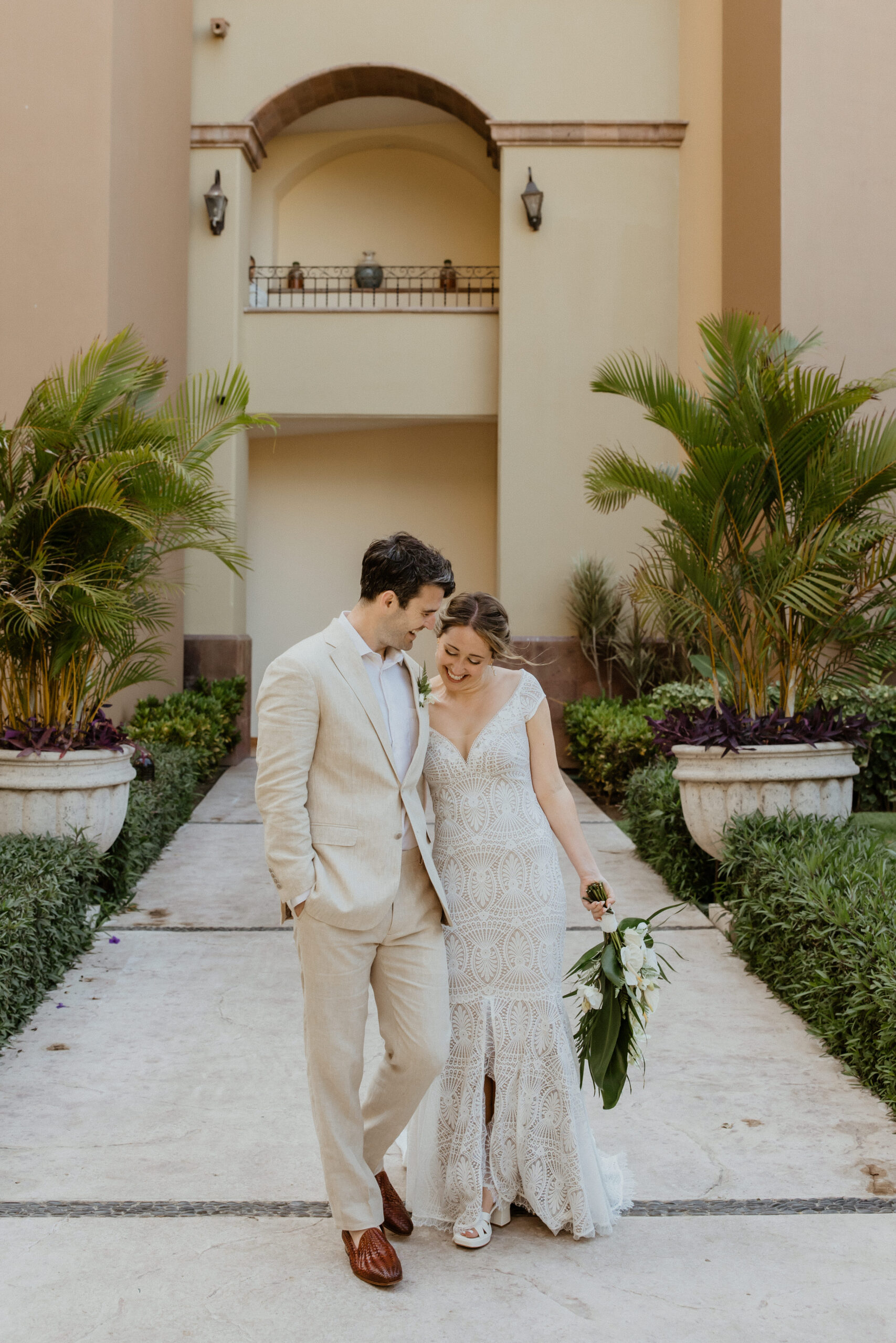 bride and groom walking with each other in puerto vallarta wedding venue.