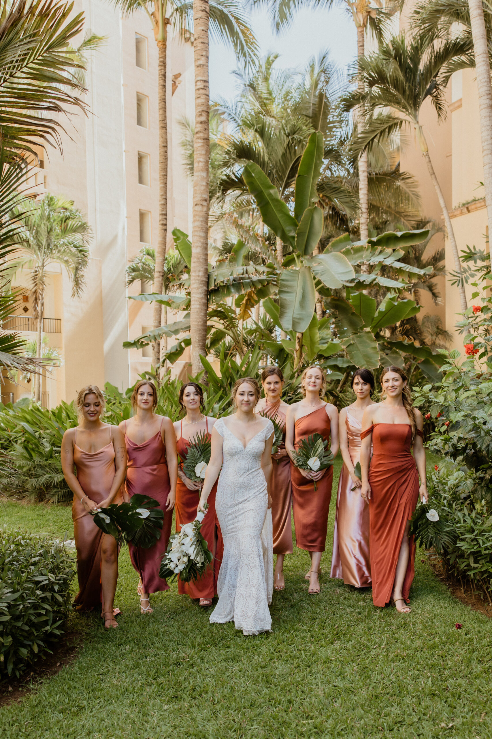 bridal party posing in terracotta bridesmaid dresses with bride.