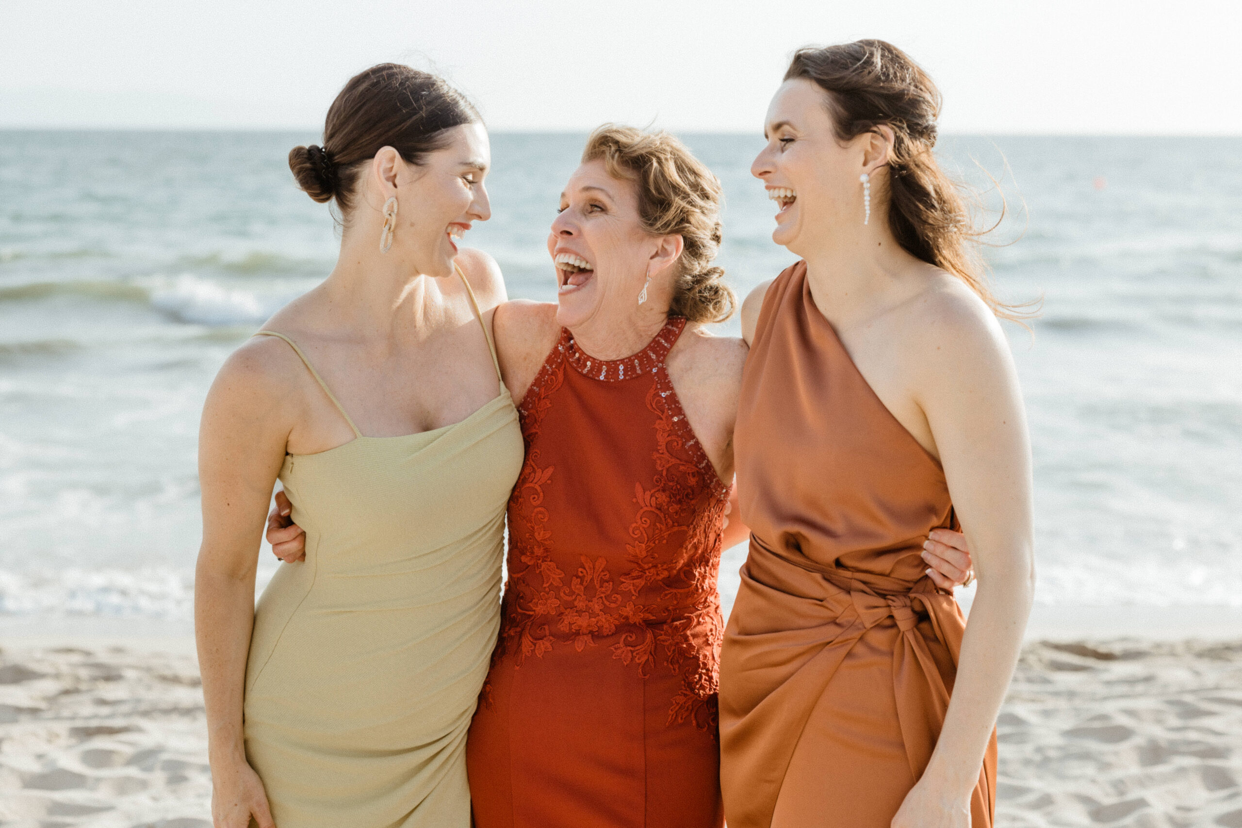 friends laughing at beach wedding in puerto vallarta.