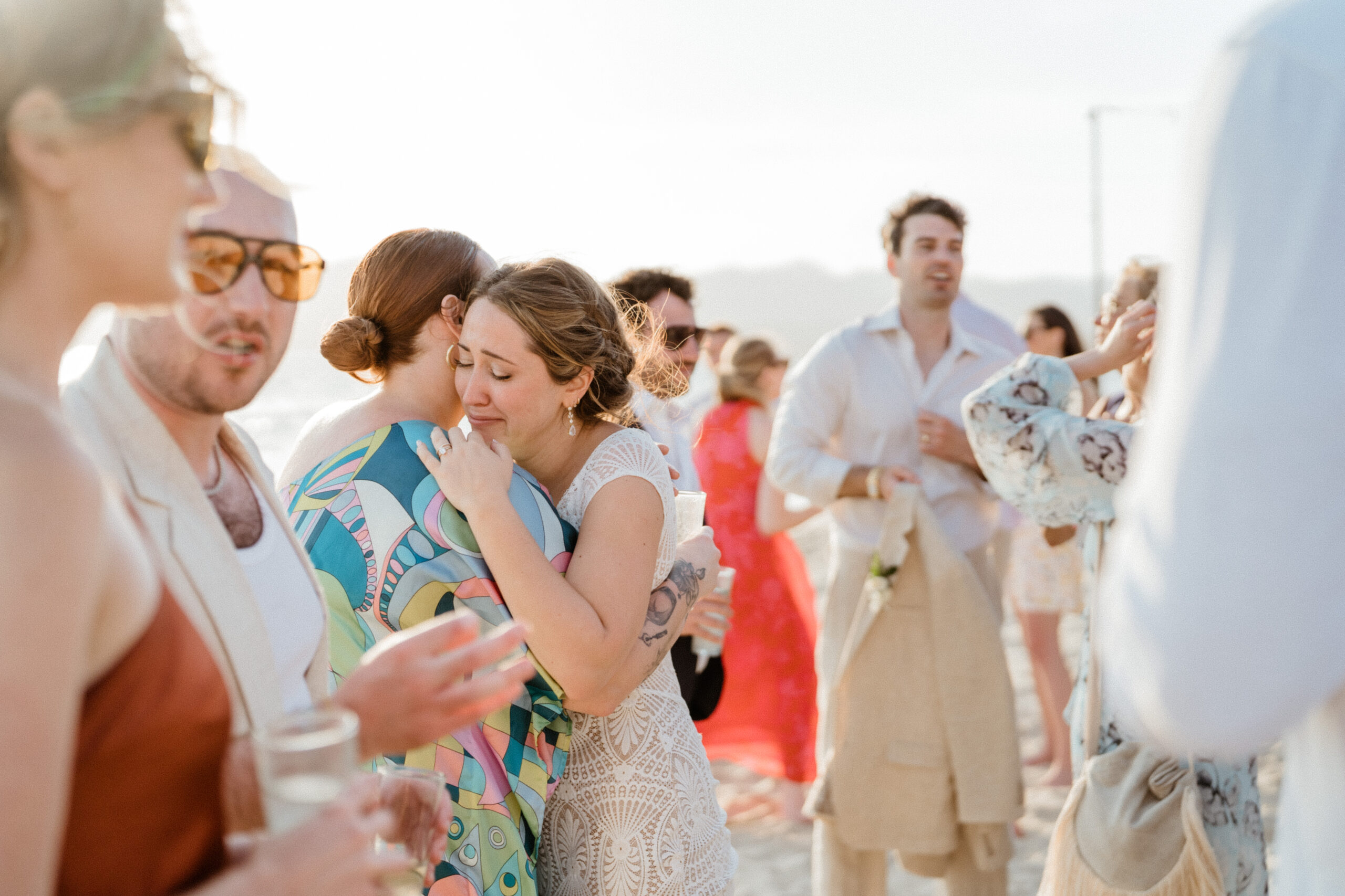 bride hugging friends in beach wedding in puerto vallarta