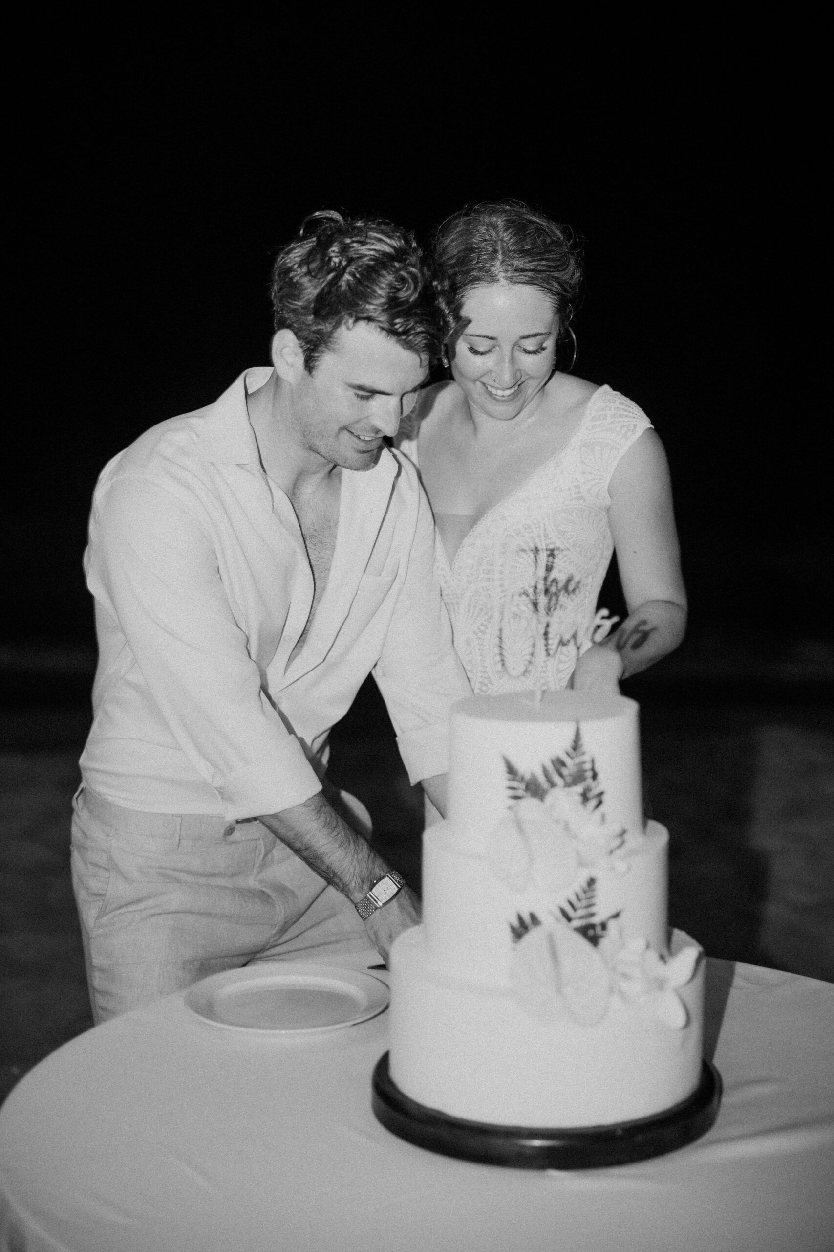 groom cutting wedding cake with bride.