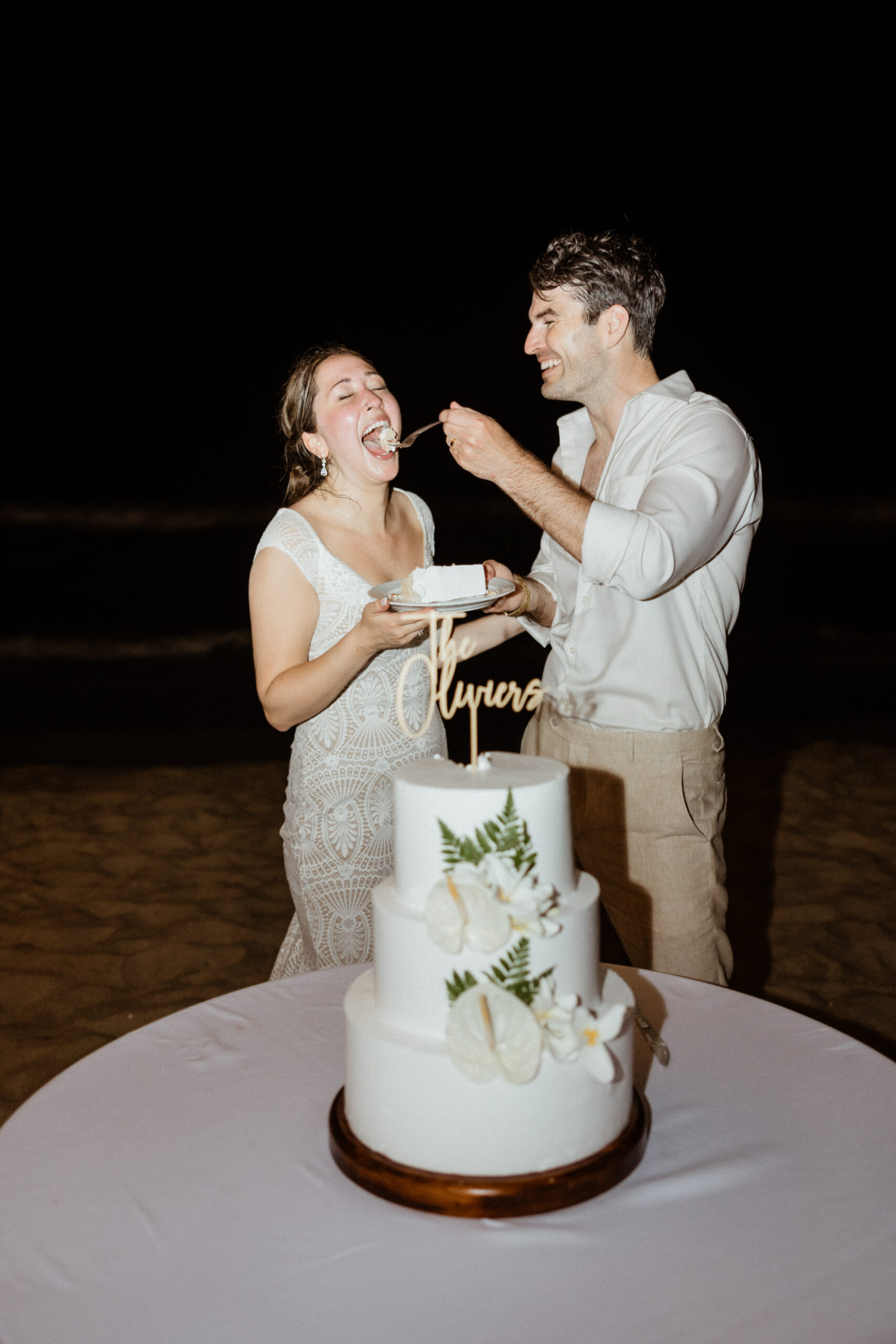 bride and groom eating wedding cake.