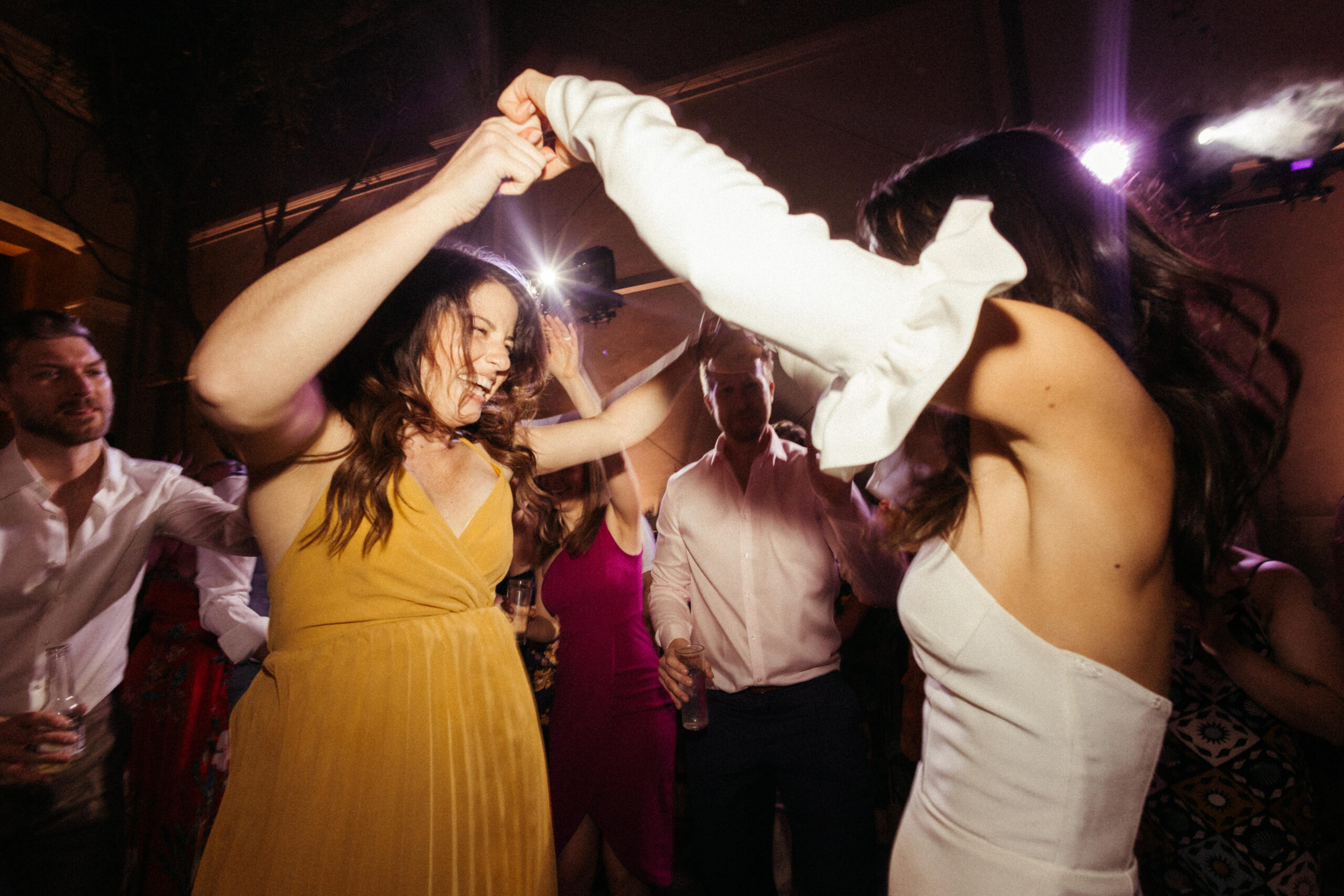 Bride and a guest share a dance during the reception at Salon Barcelona! 