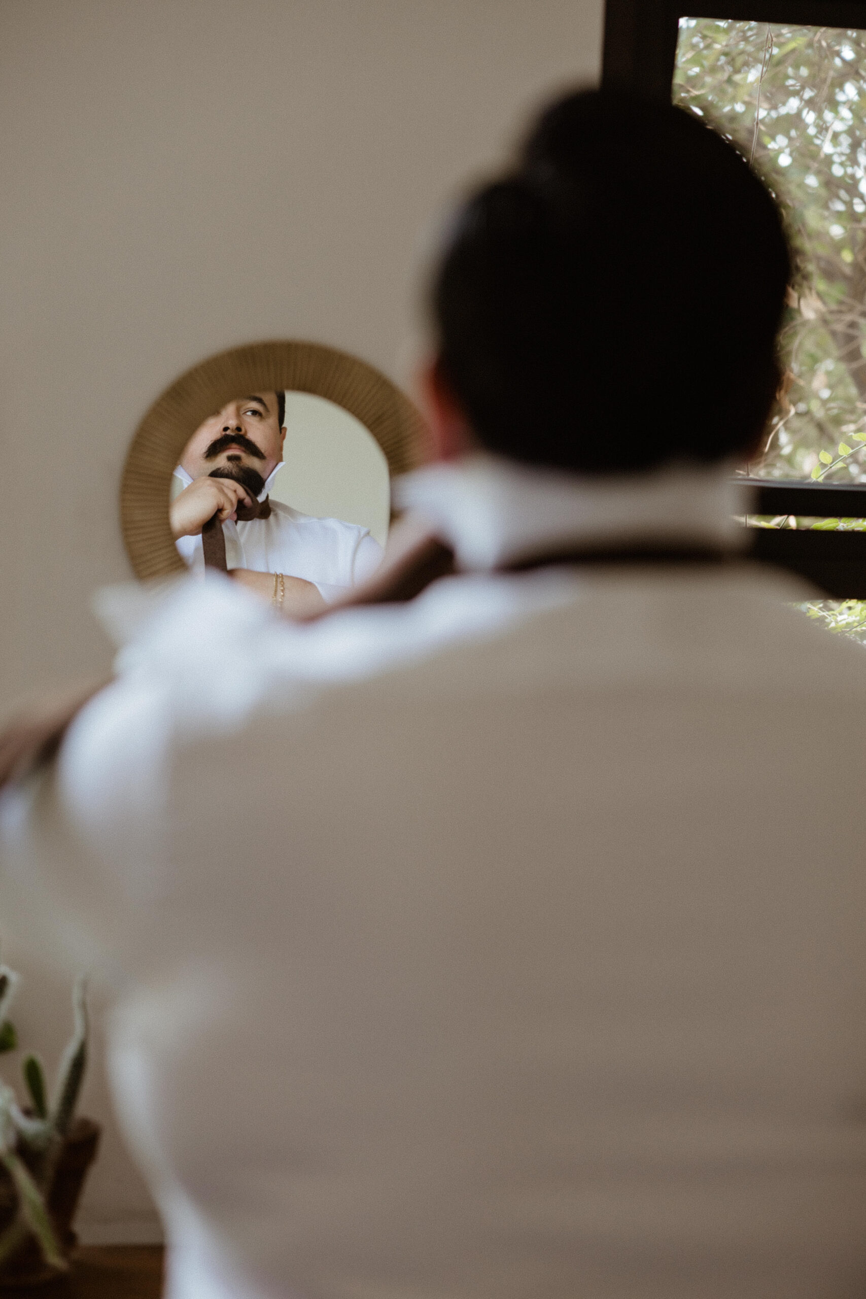 The handsome groom adds the final touches as he preps for his wedding day