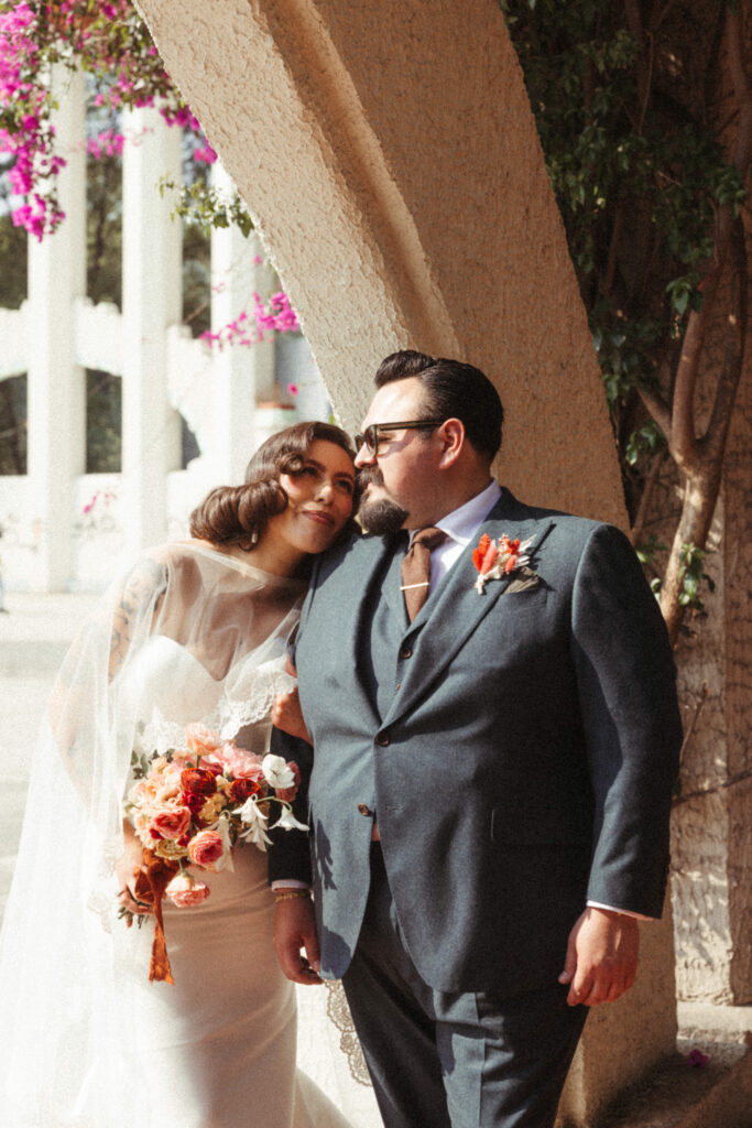 Stunning bride and groom pose together outside their Sobremesa wedding venue