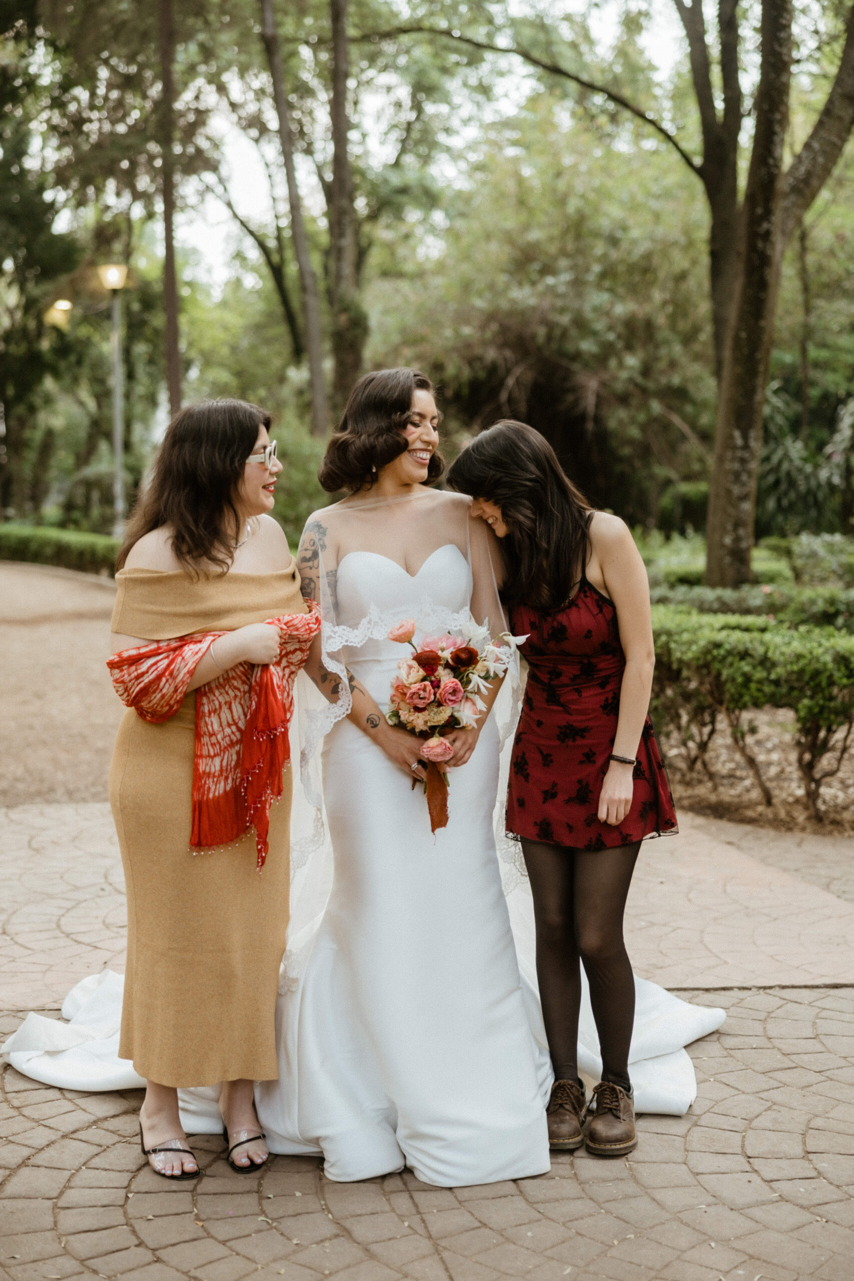 The stunning bride poses with two of her bridesmaids outside her Sobremesa wedding venue
