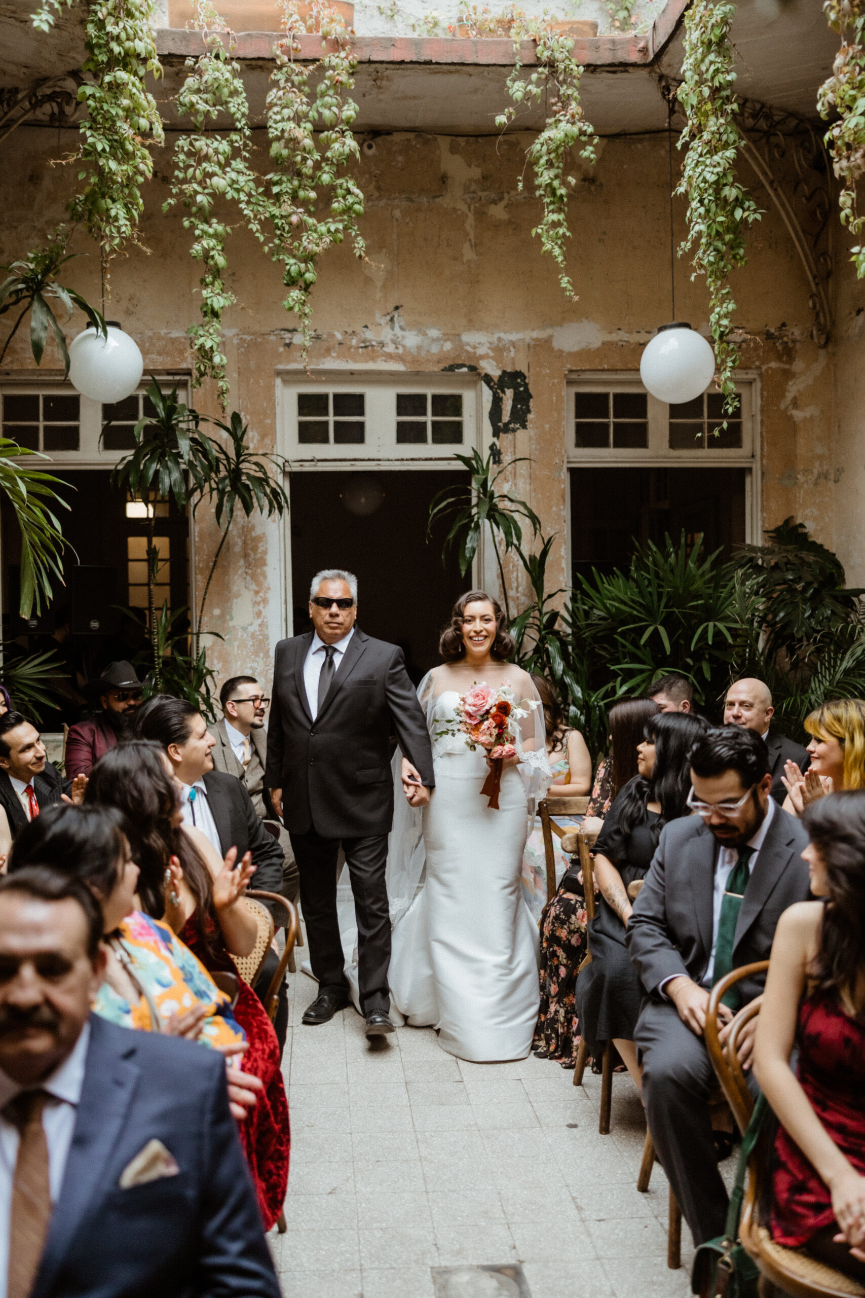 The stunning bride walks down the aisle with her father