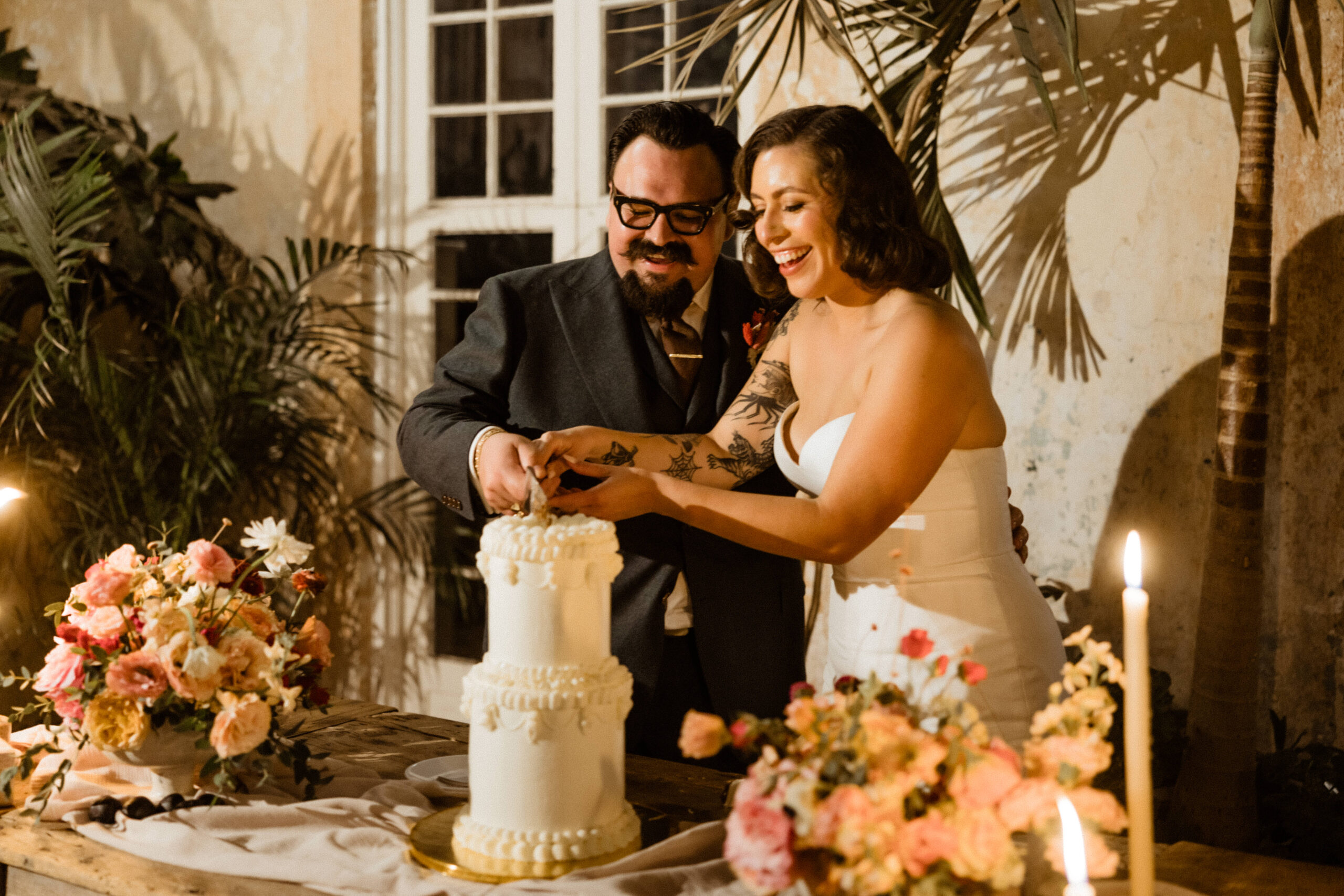 Stunning bride and groom cut their cake together at their Sobremesa Mexico destination wedding