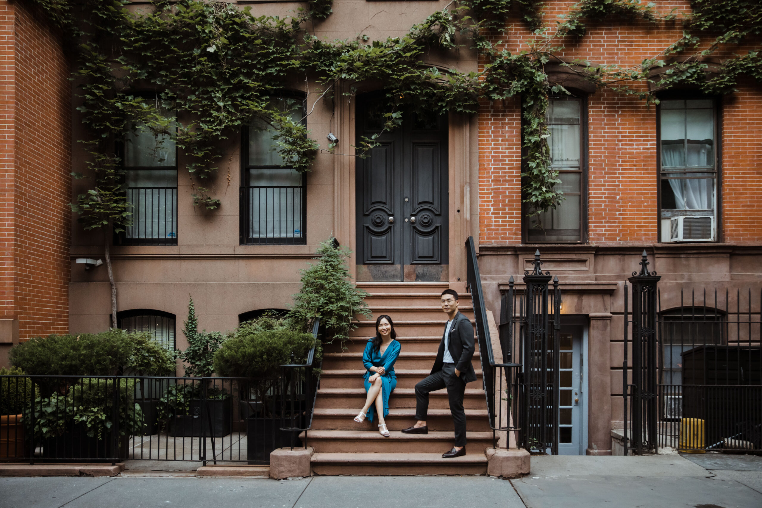 Beautiful couple pose on the steps in the West Village during their New York engagement session