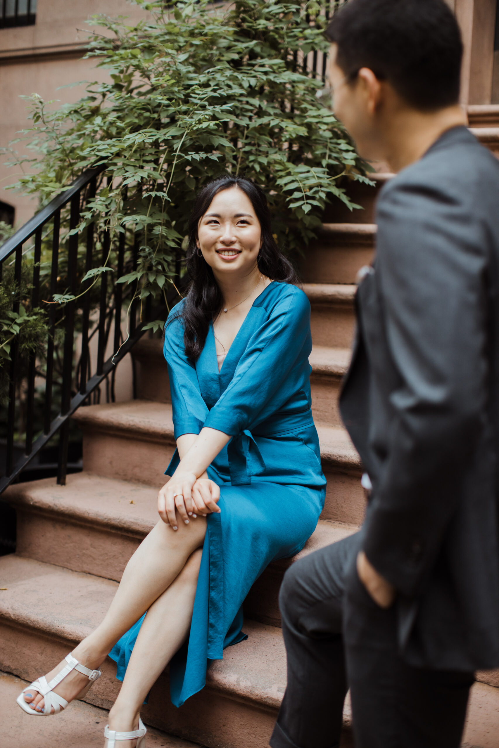 Beautiful couple sit on the steps in the West Village during their romantic West Village engagement photos