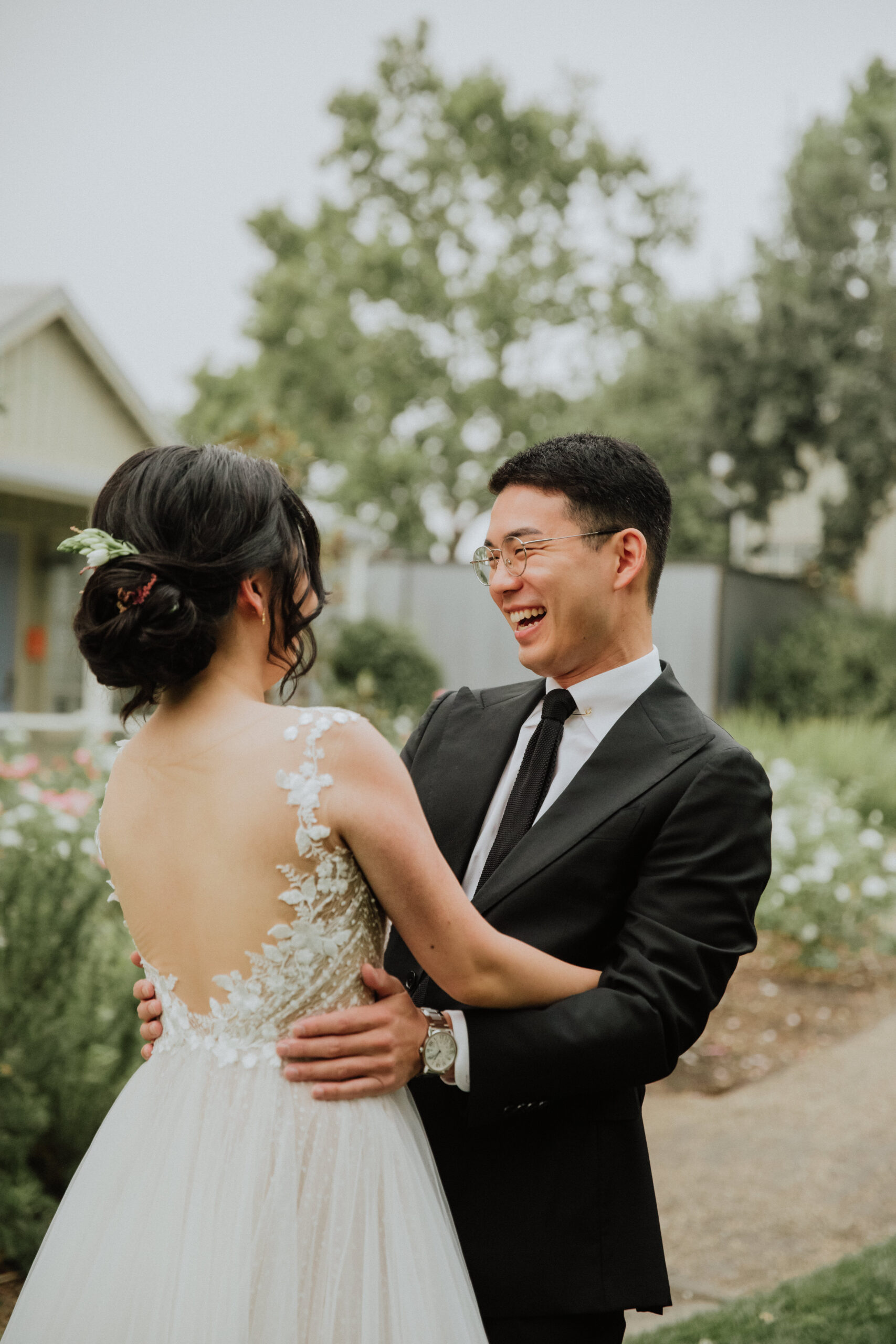 Stunning bride and groom share first look photos before their vineyard wedding ceremony