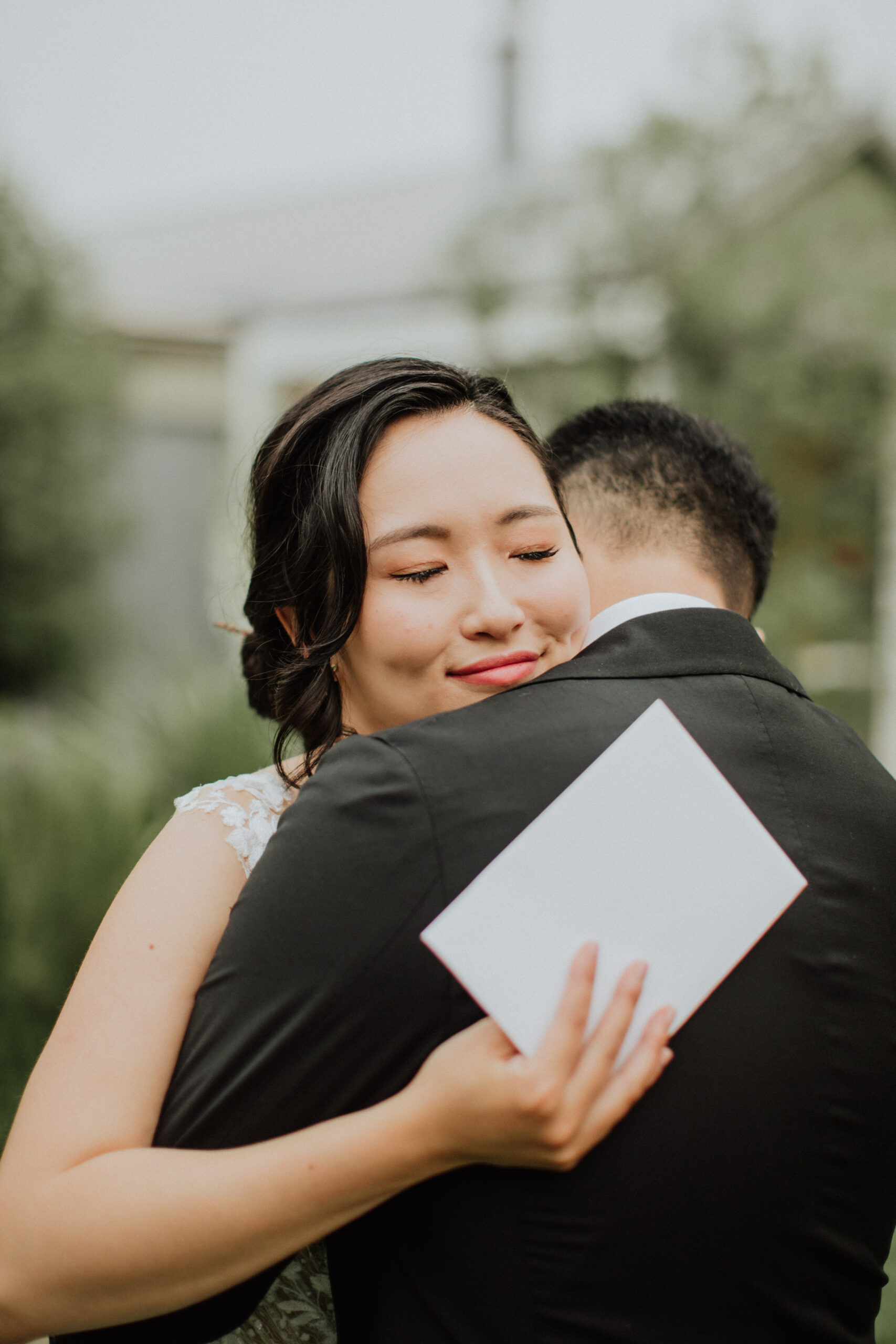 bride hugging husband after reading vows.