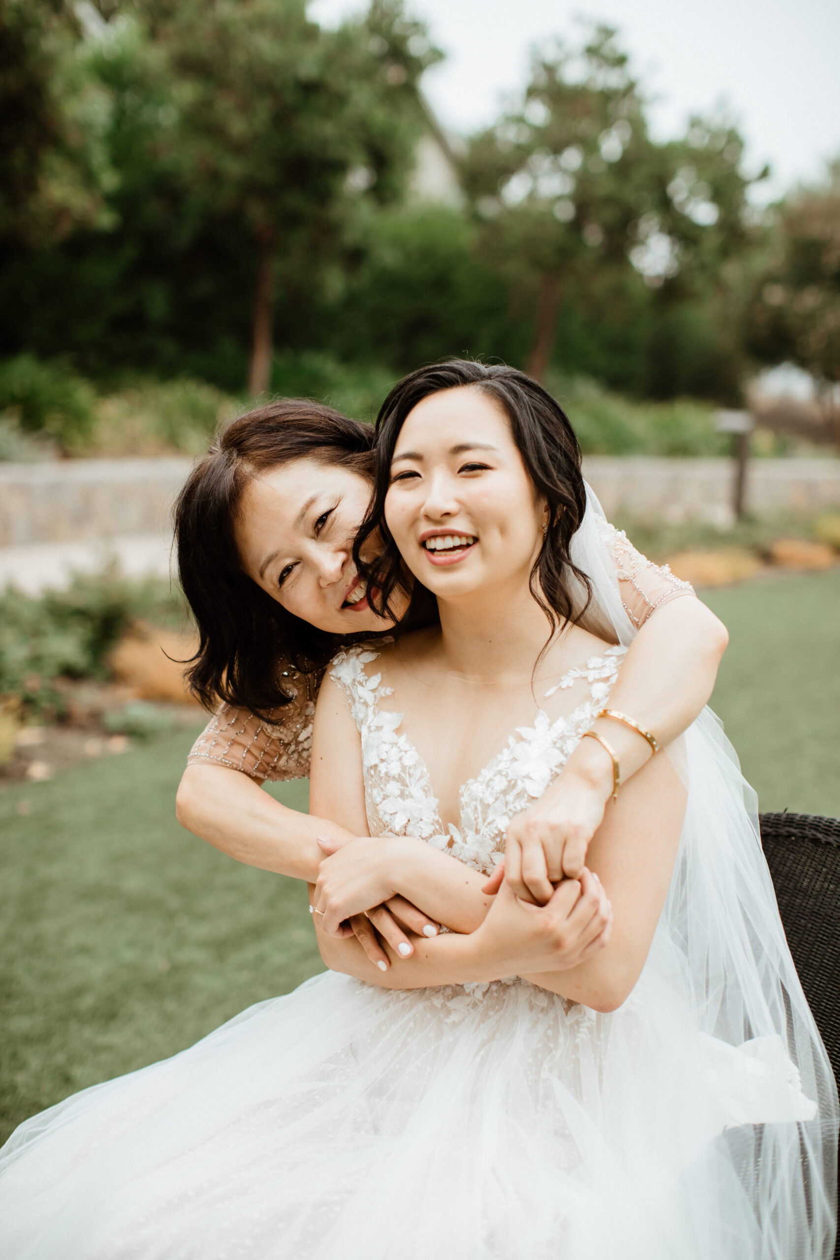 Stunning bride poses with a family member during her wedding day