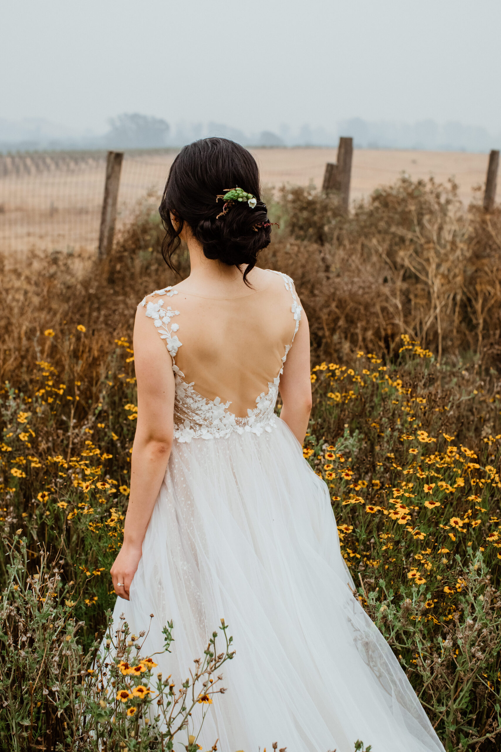 Stunning bride overlooks the vineyard after her Napa valley wedding
