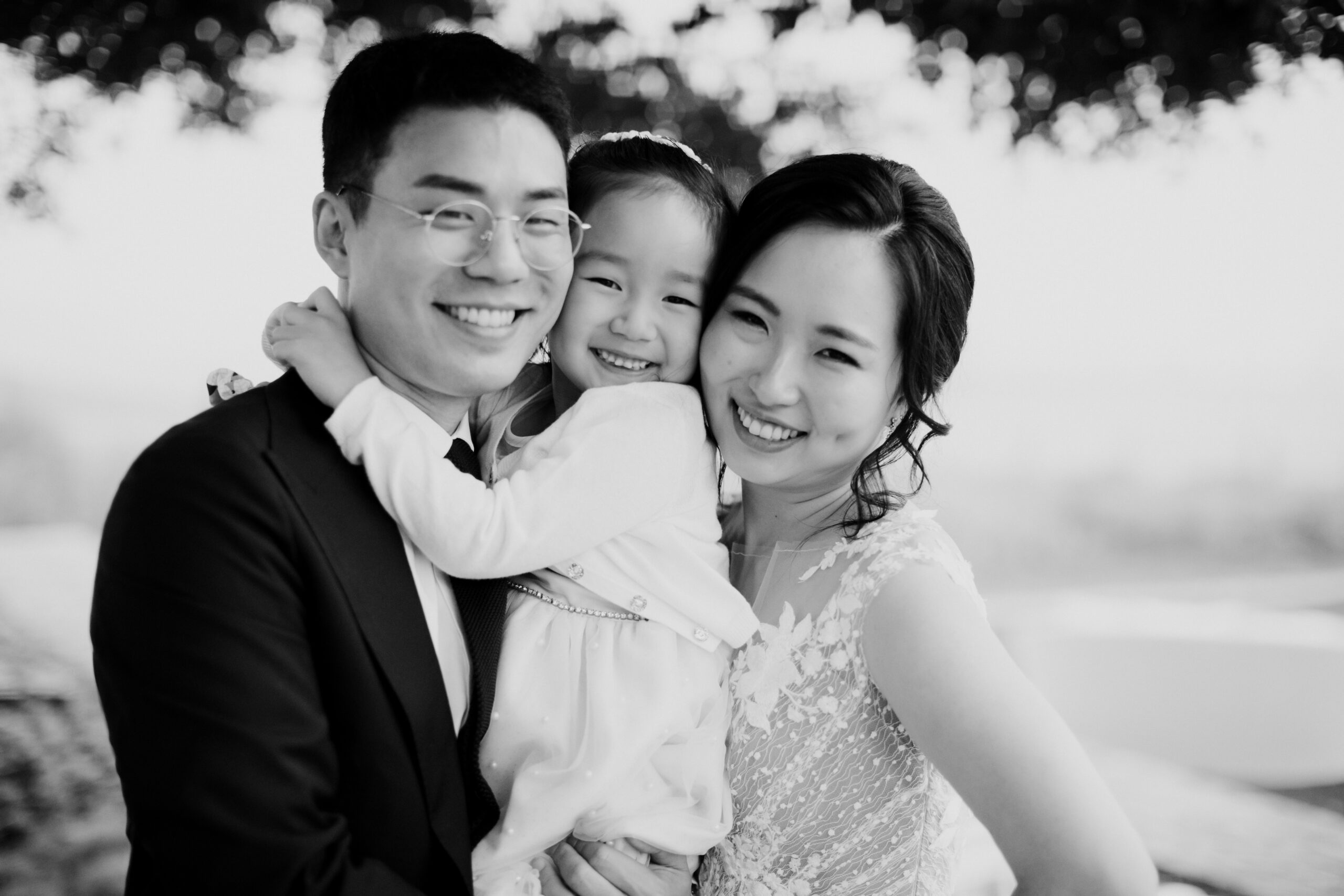 Stunning bride and groom pose with their flower girl after their Napa valley wedding day