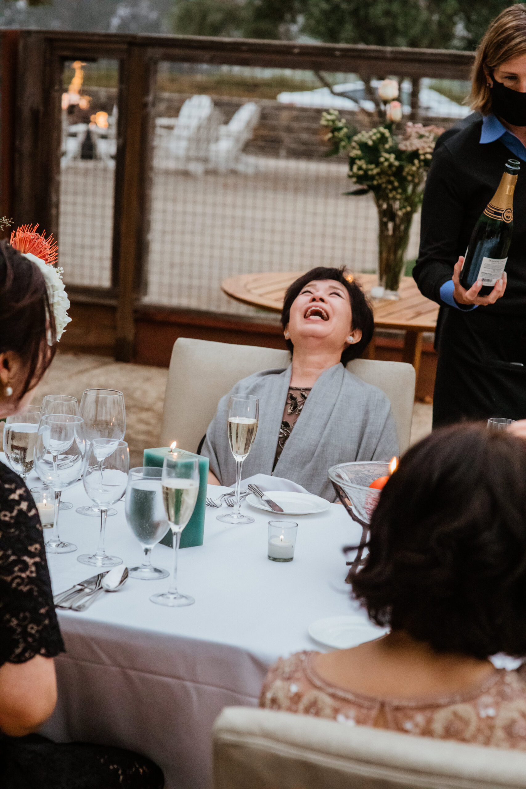 Family members laugh and celebrate during the reception at Napa valley vineyard wedding