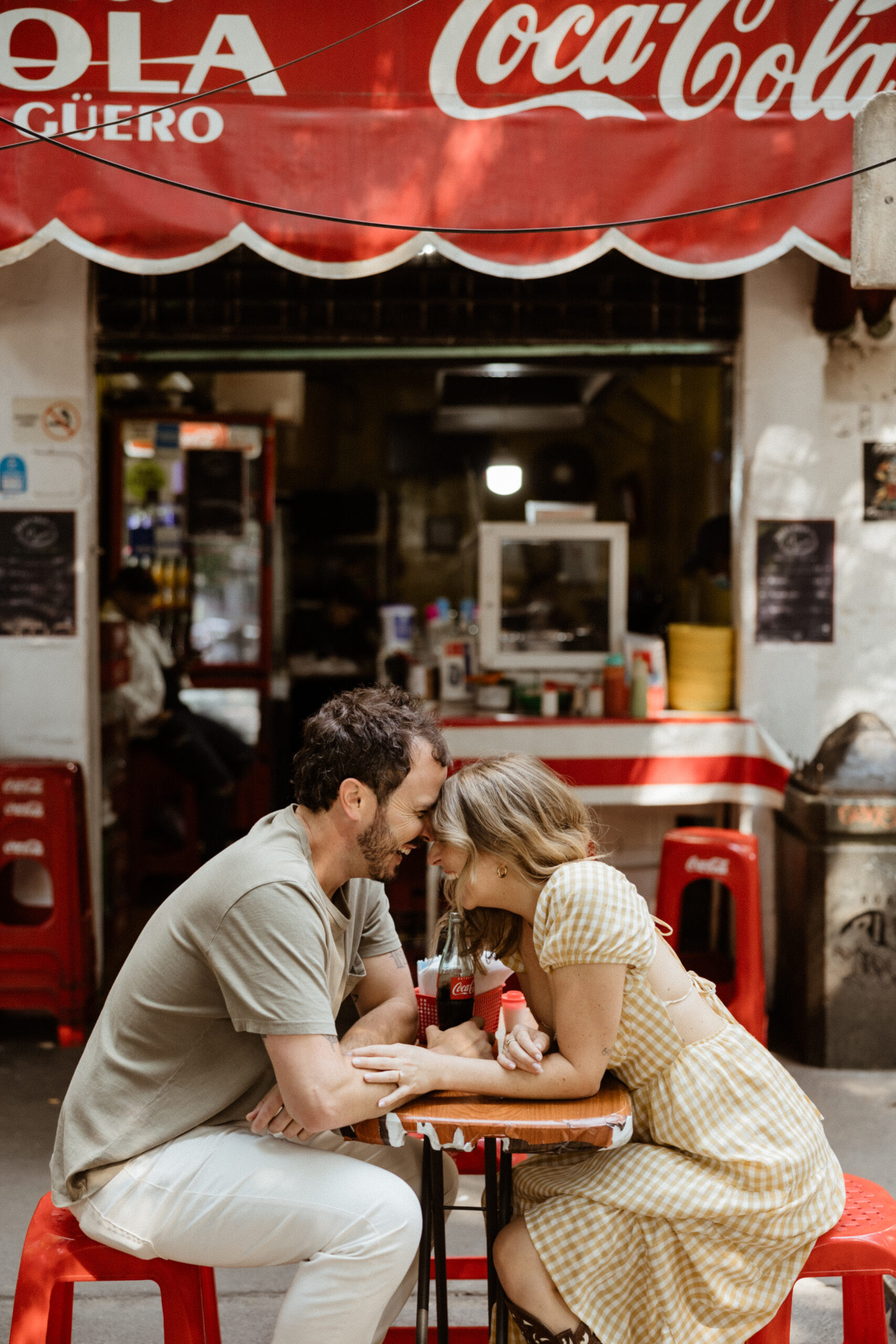 man and woman laughing while at local restaurant 
