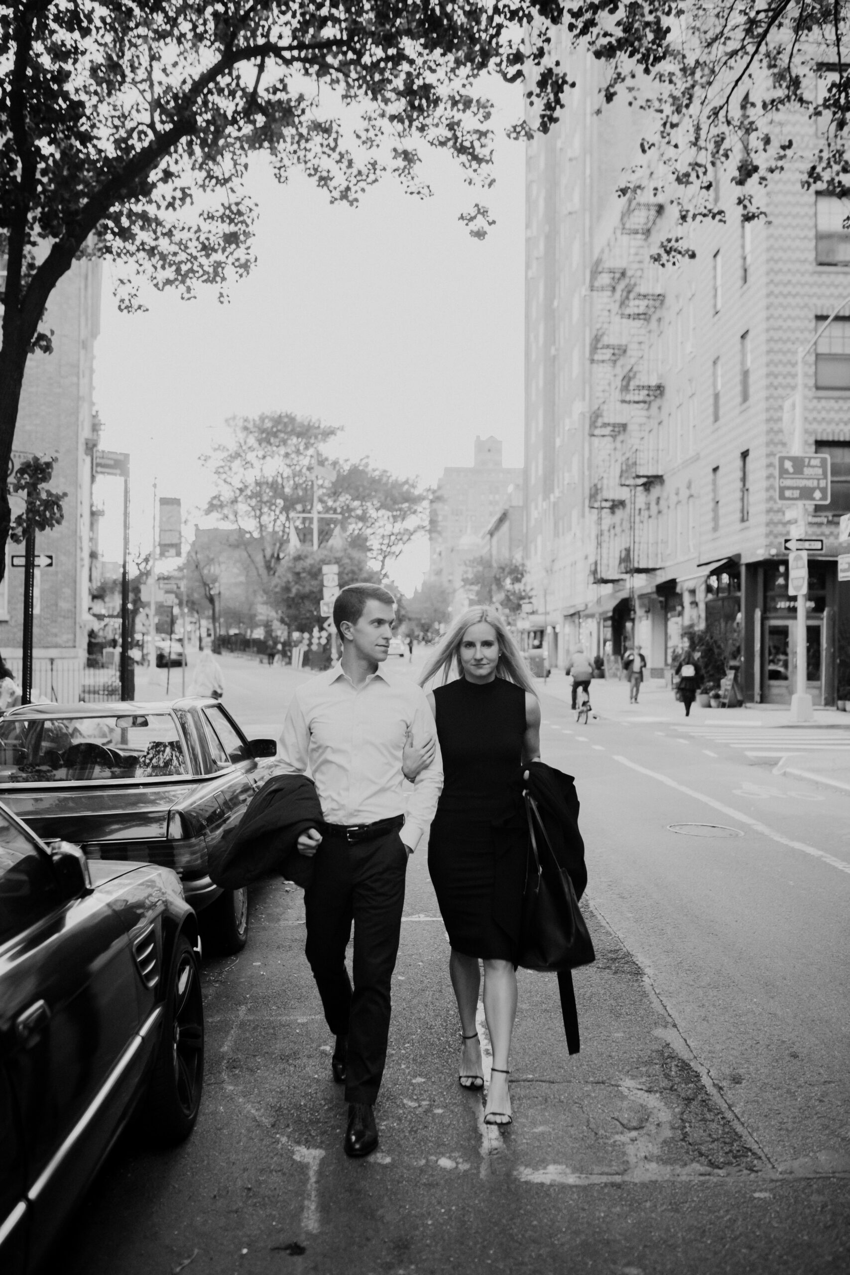 Stunning couple walk together in the West Village during their dreamy outdoor engagement photos in New York 
