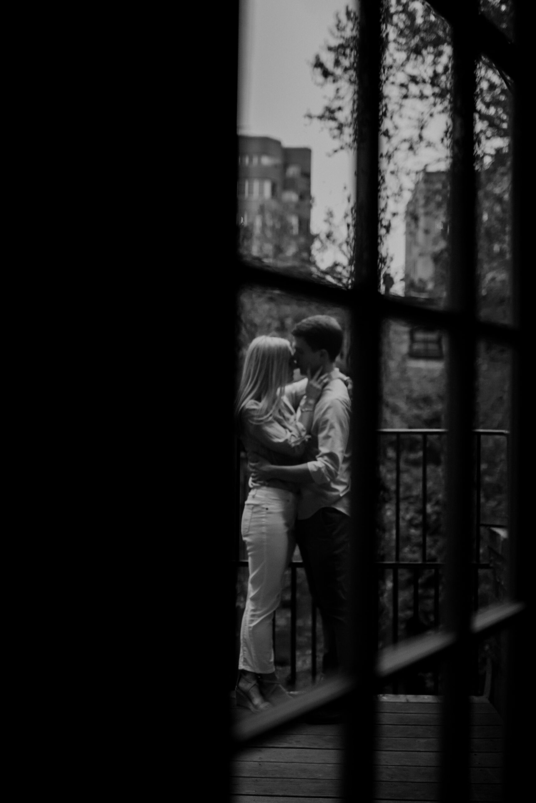 Gorgeous couple share a kiss during their dreamy outdoor engagement photos in West Village New York 