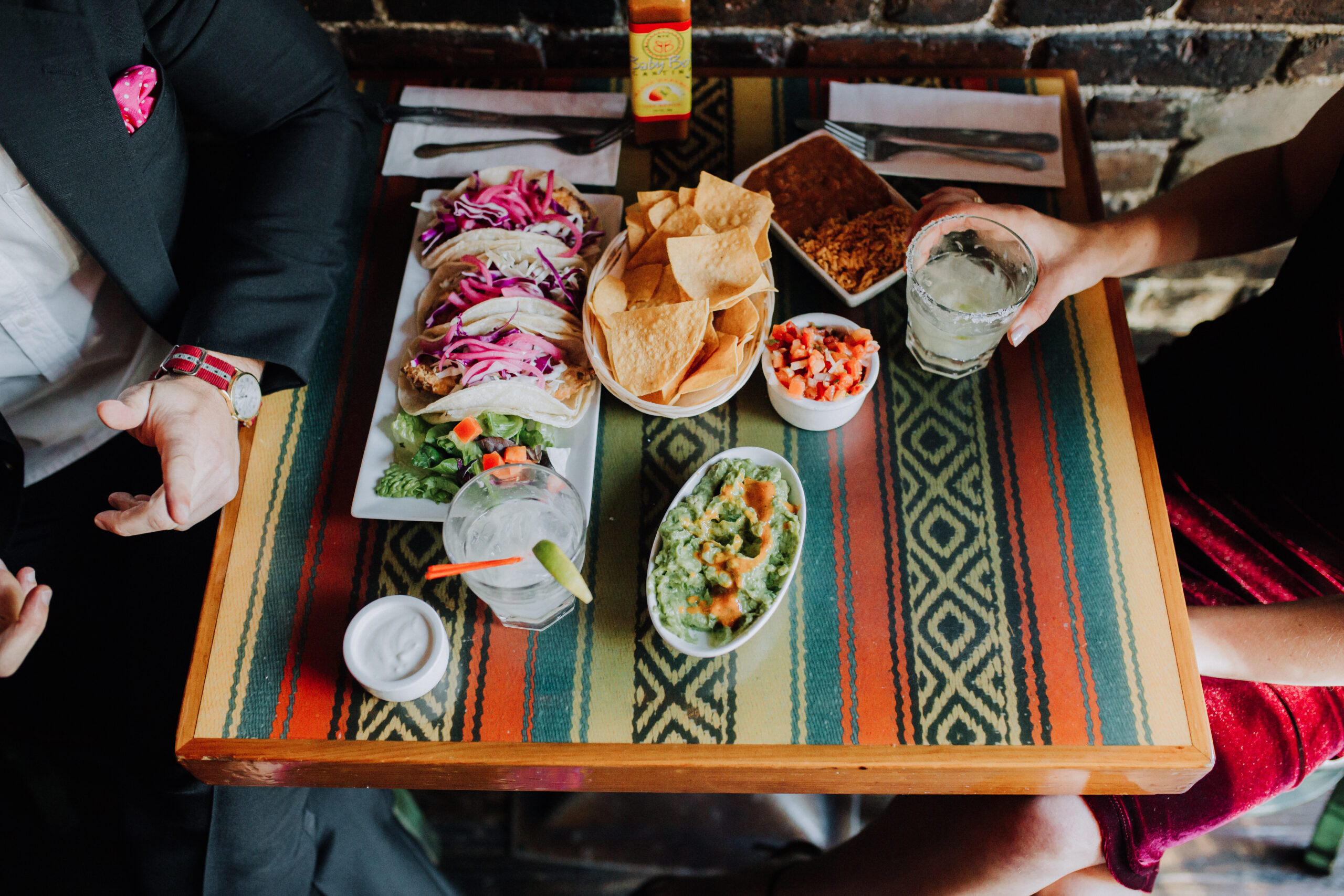 Stunning couple shares a colorful meal during their dreamy bar engagement photoshoot