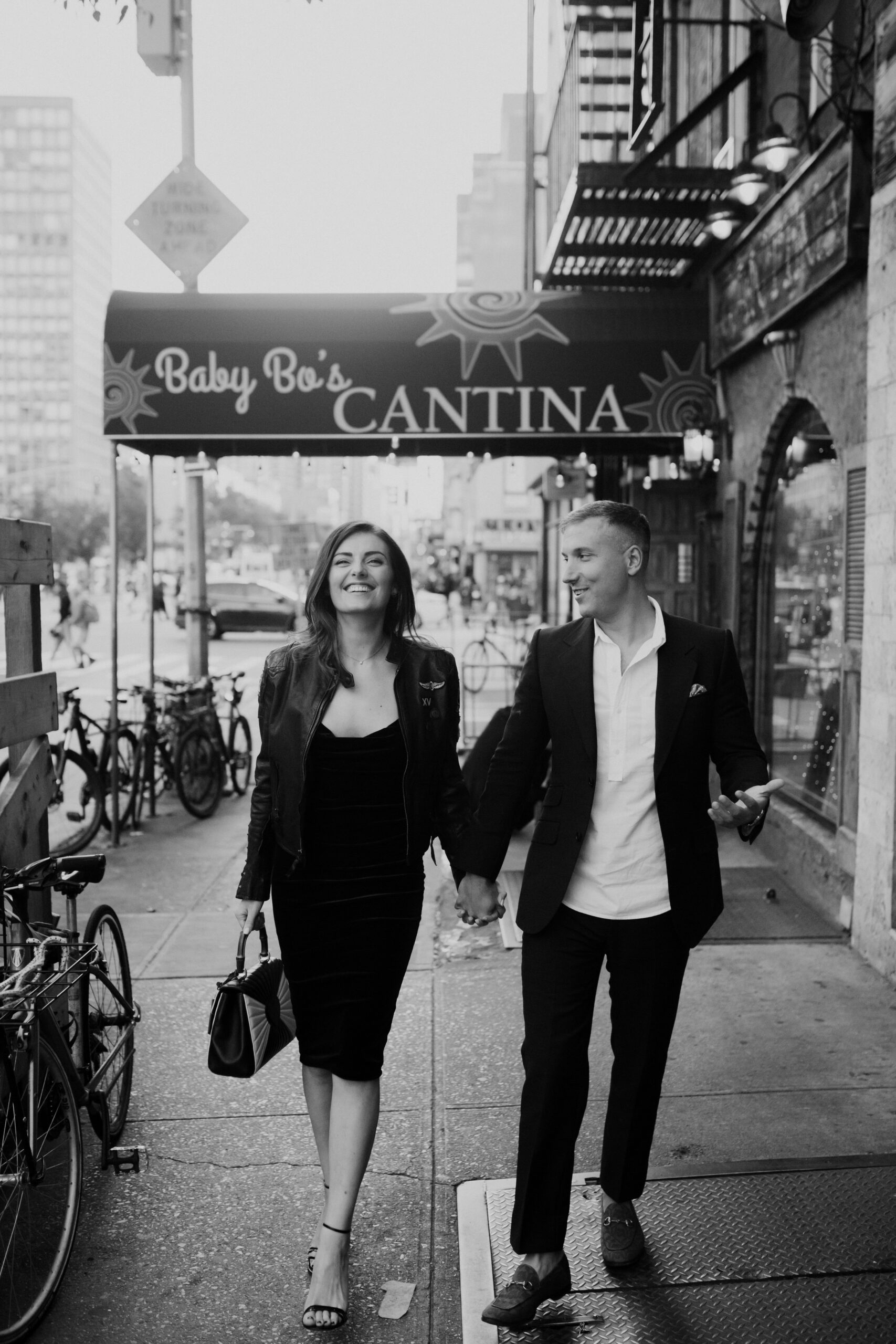 black and white photo of couple walking in downtown new york. 
