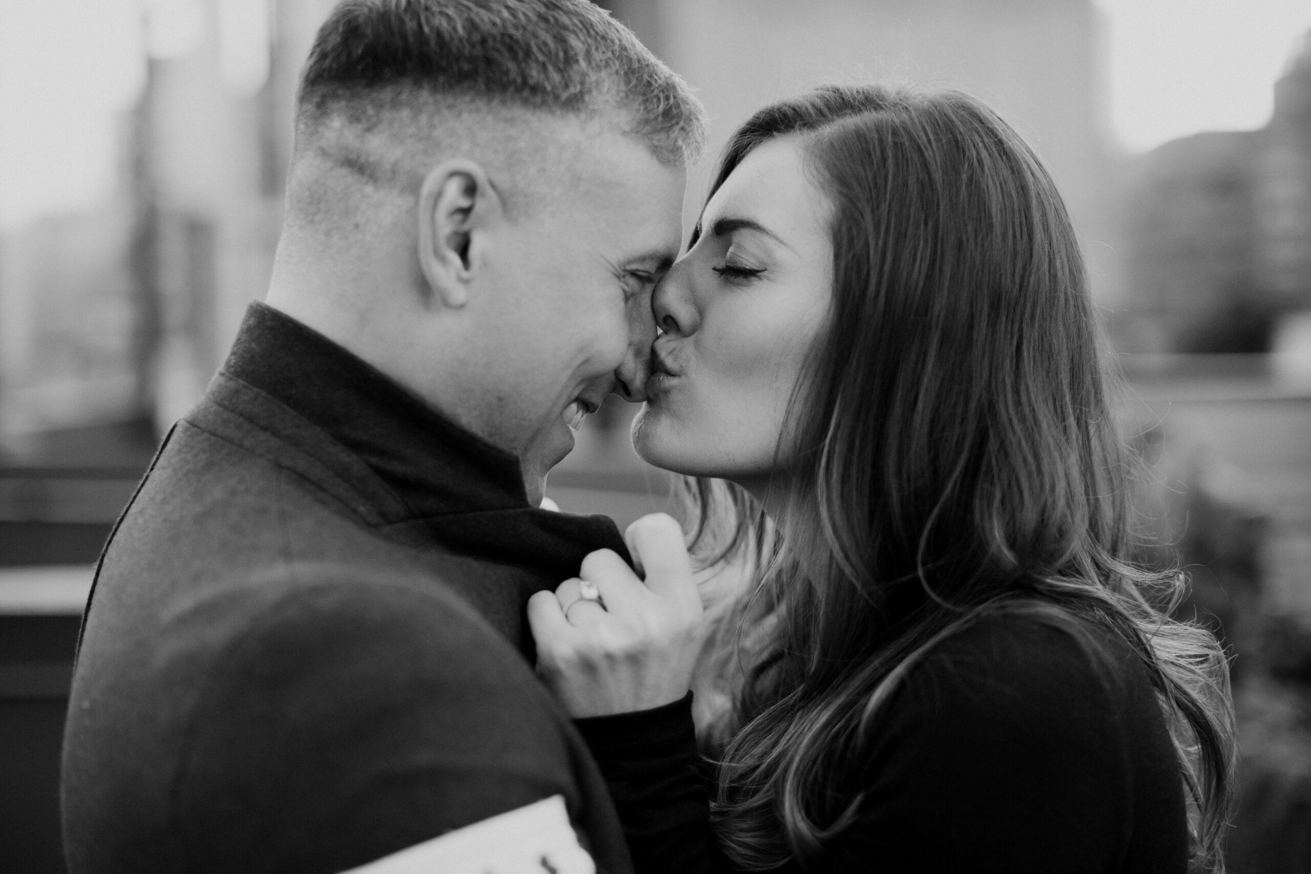 fiance kissing partner in black and white photo. 
