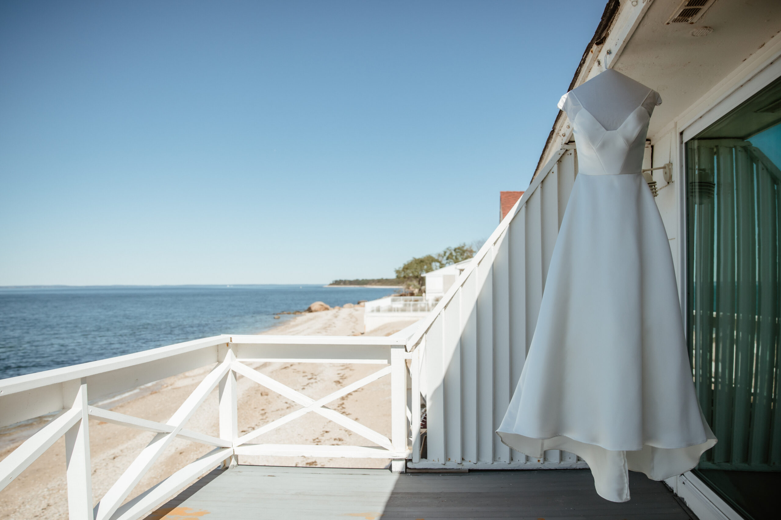 A minimalist bridal dress hangs on display before the wedding day at Bedell Cellars, NY