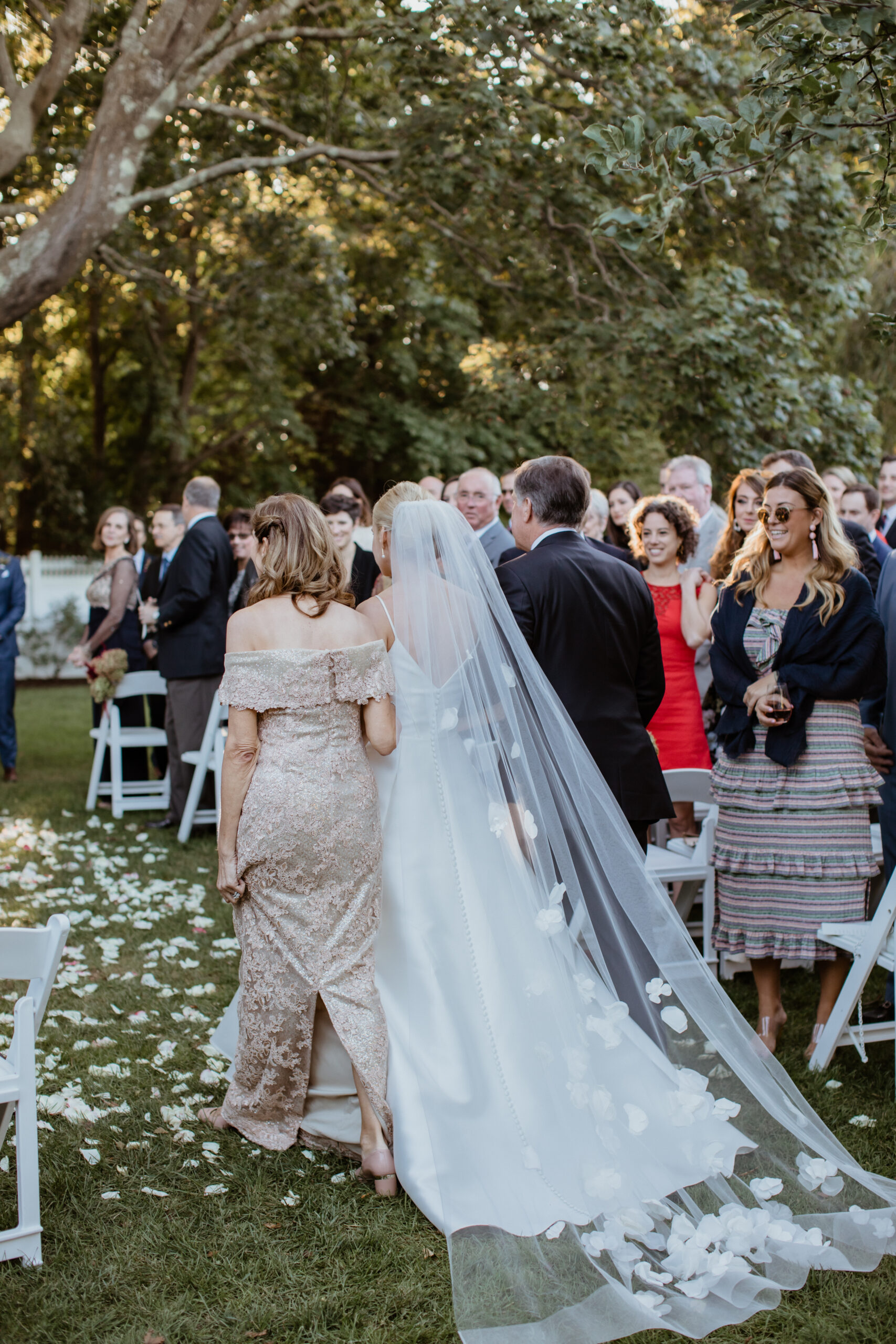 Stunning bride walks down the aisle with her mom and dad