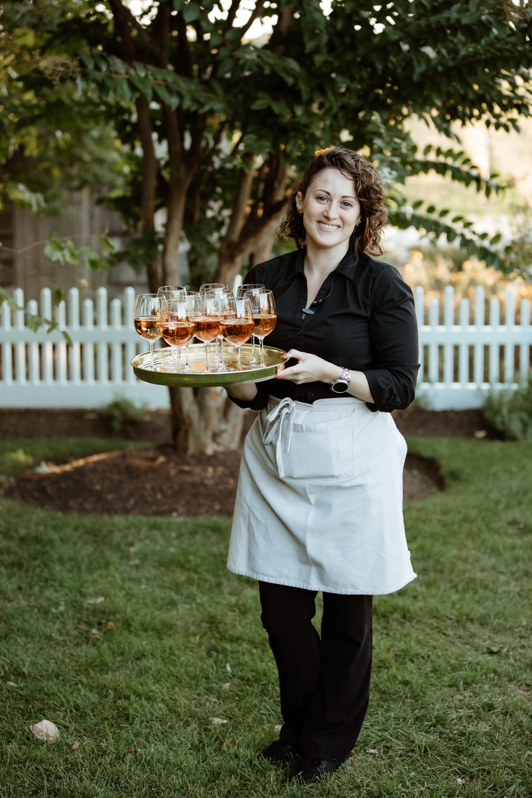 Bedell winery employee serves cocktails during cocktail hour at the stunning Bedell Winery wedding!