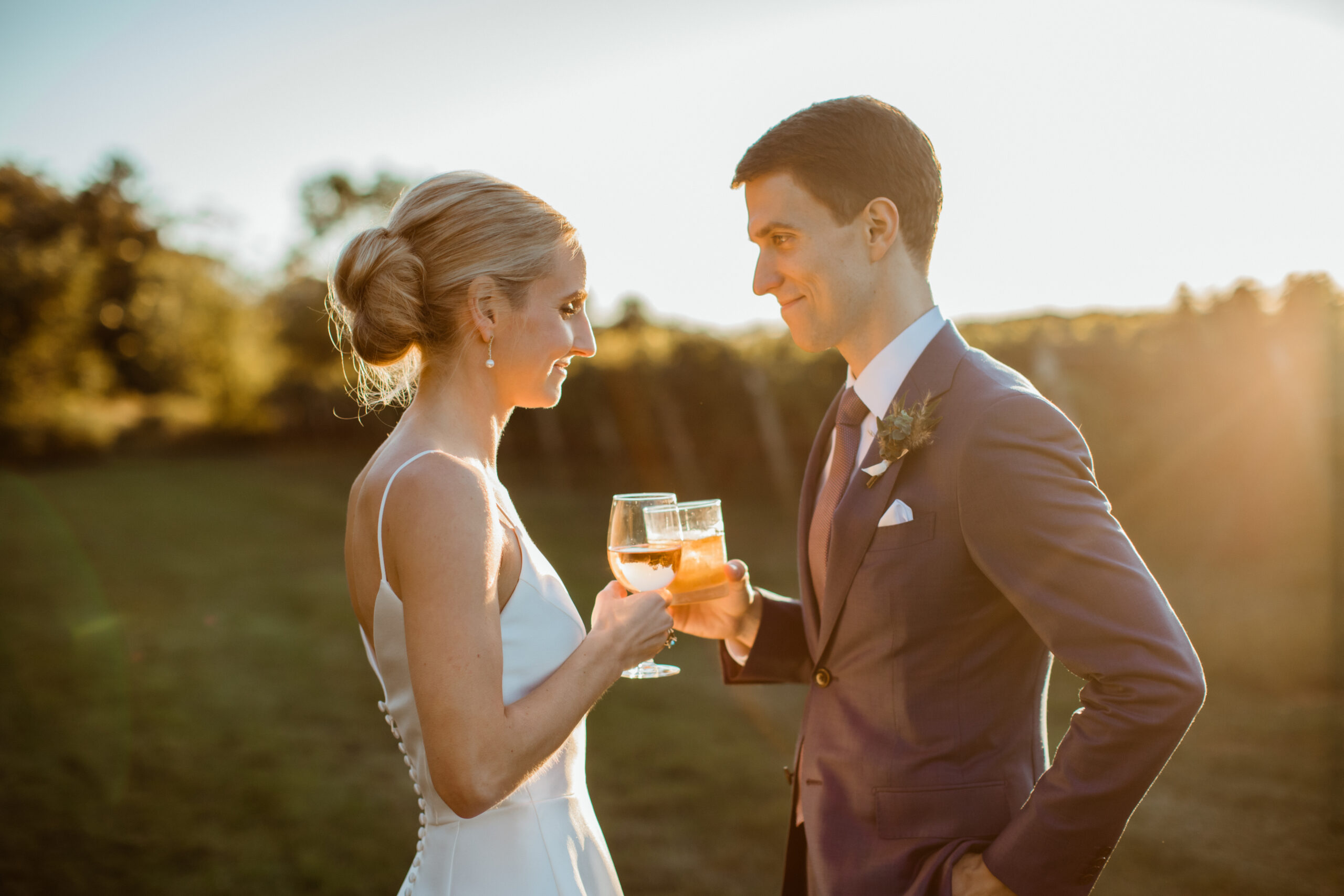 Stunning bride and groom share drinks at the venue of Bedell Cellars