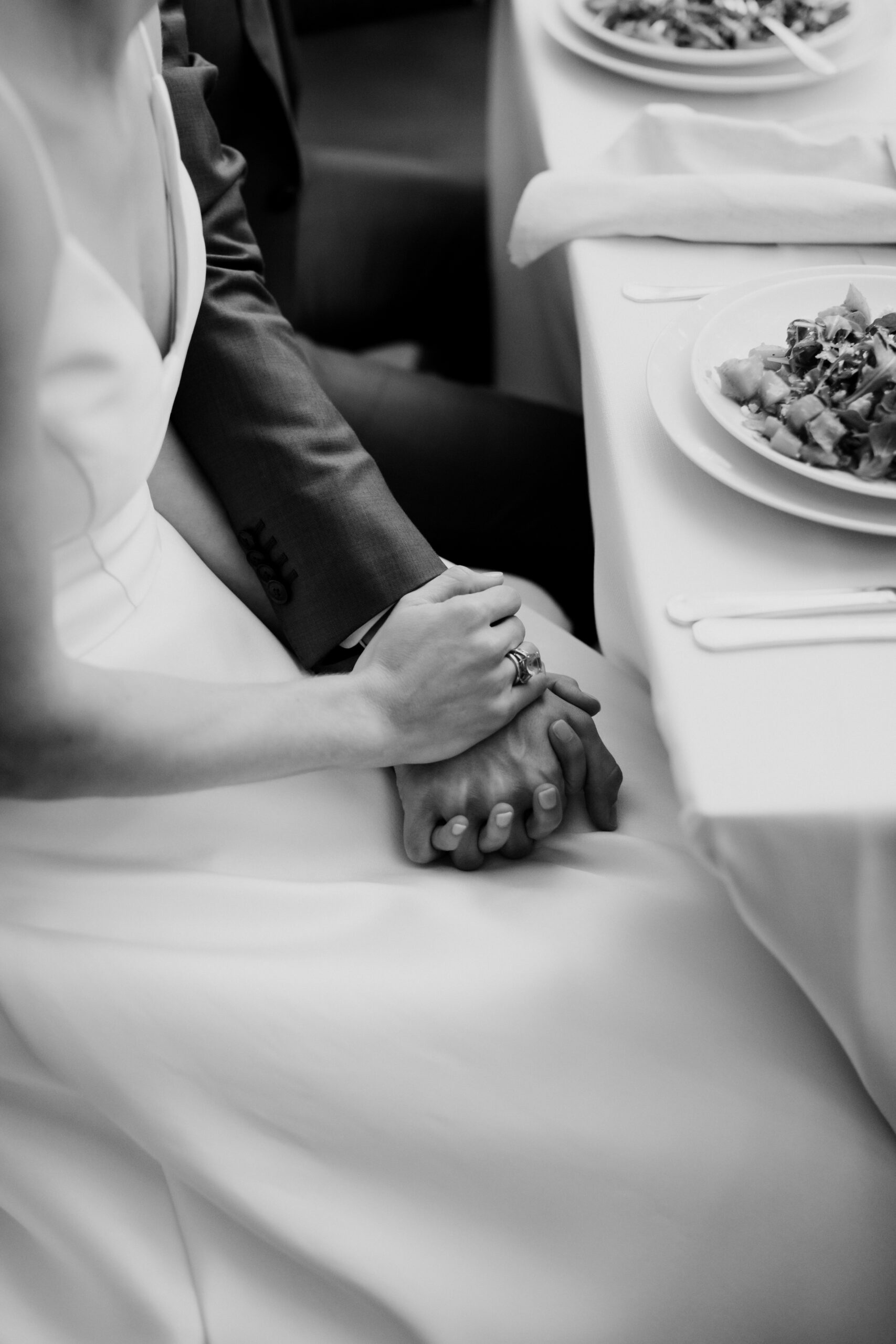Bride and groom hold hands for comfort during their dreamy New York winery wedding