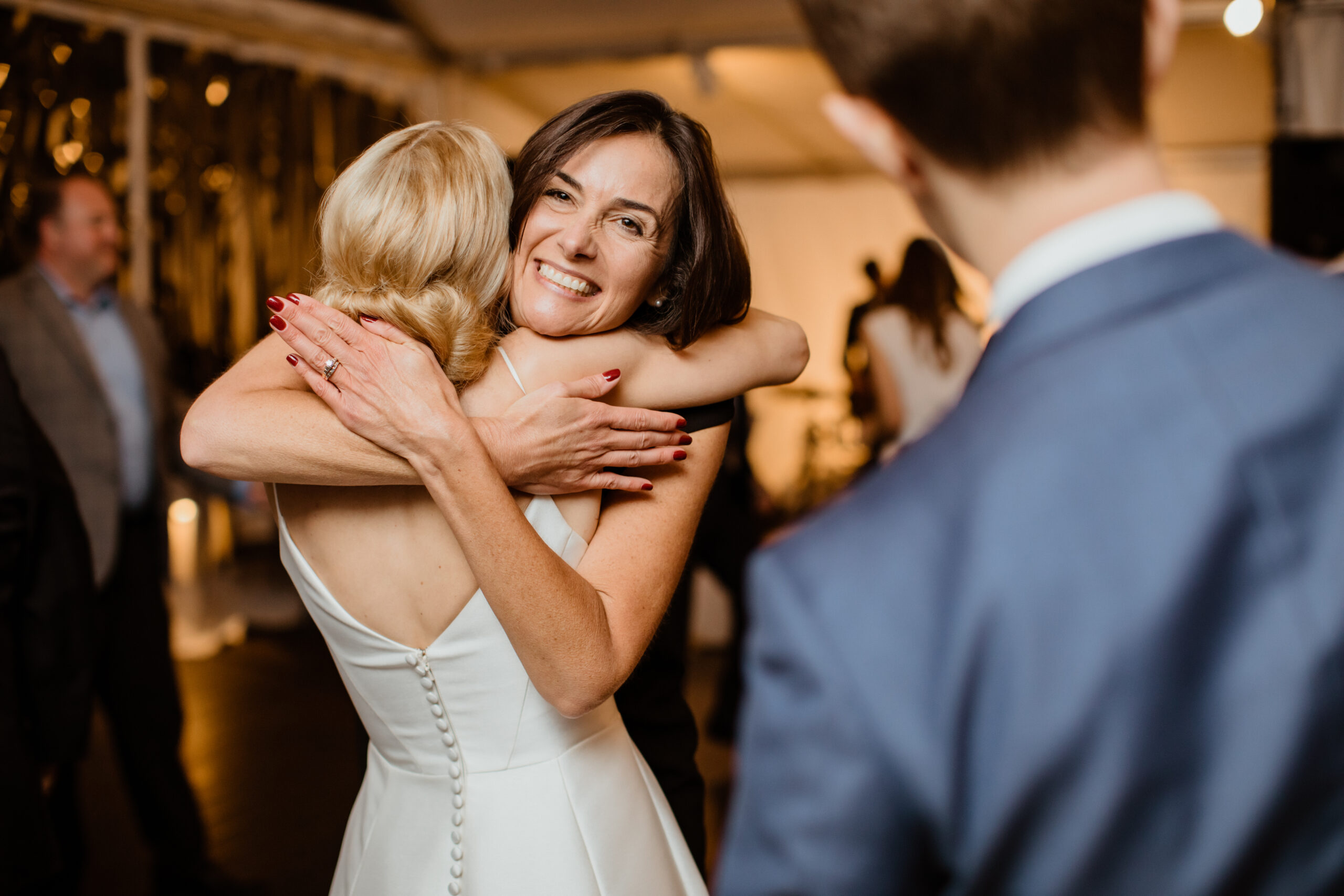 Stunning bride embraces a friend on her dreamy New York wedding day
