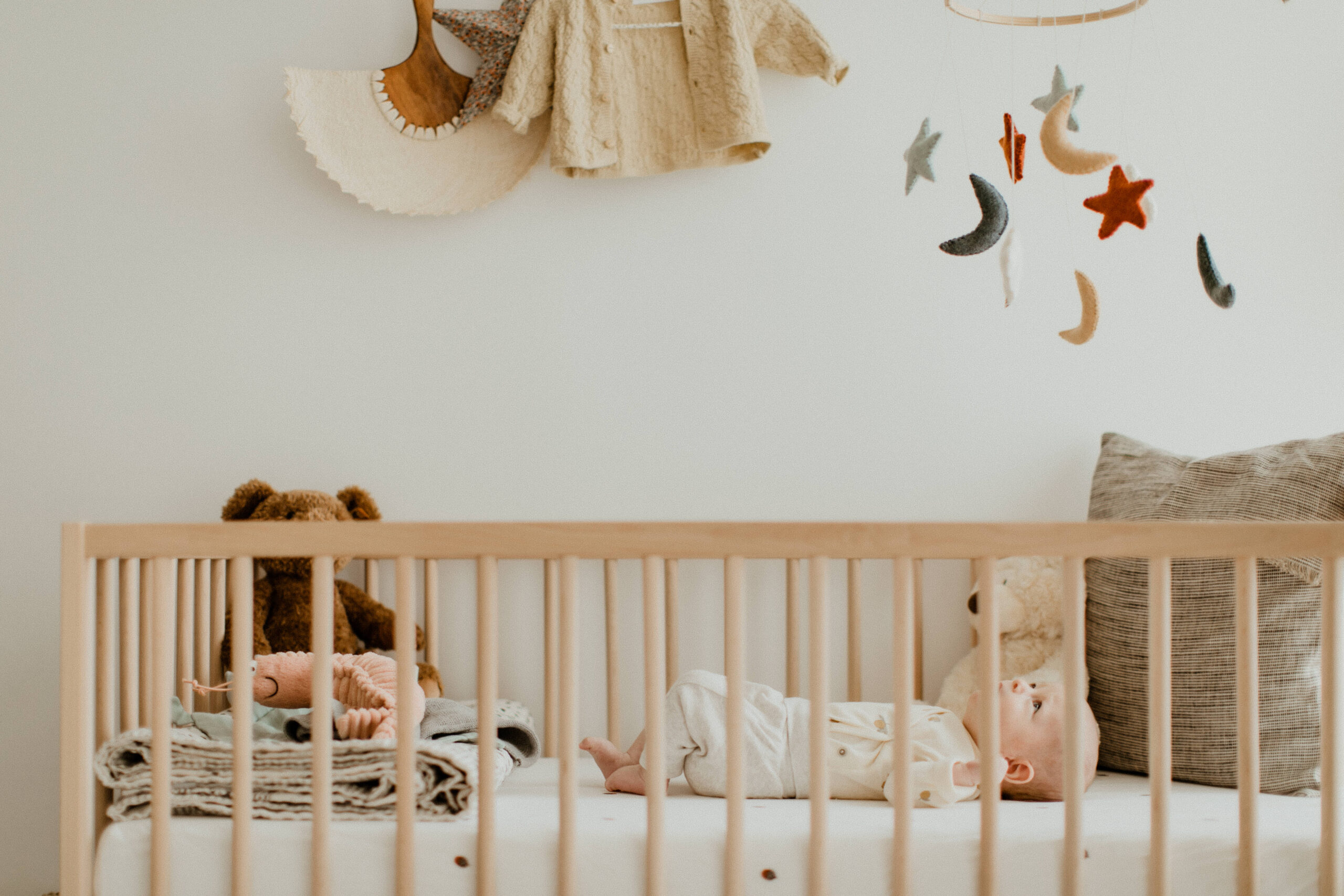 baby lying in crib during newborn in home photo session