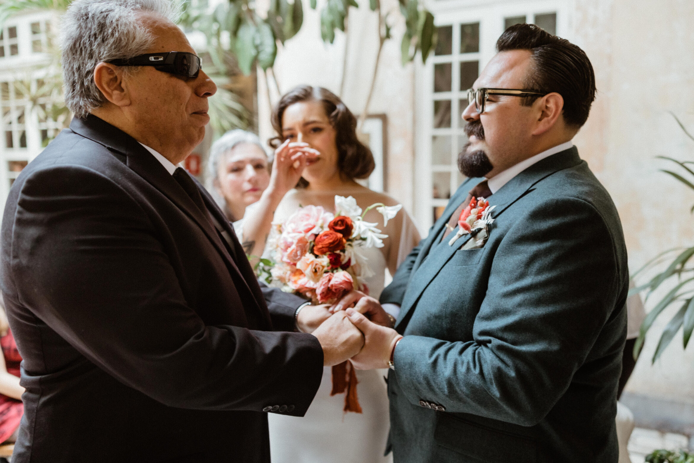 The stunning brides father gives his daughter away at the end of the aisle