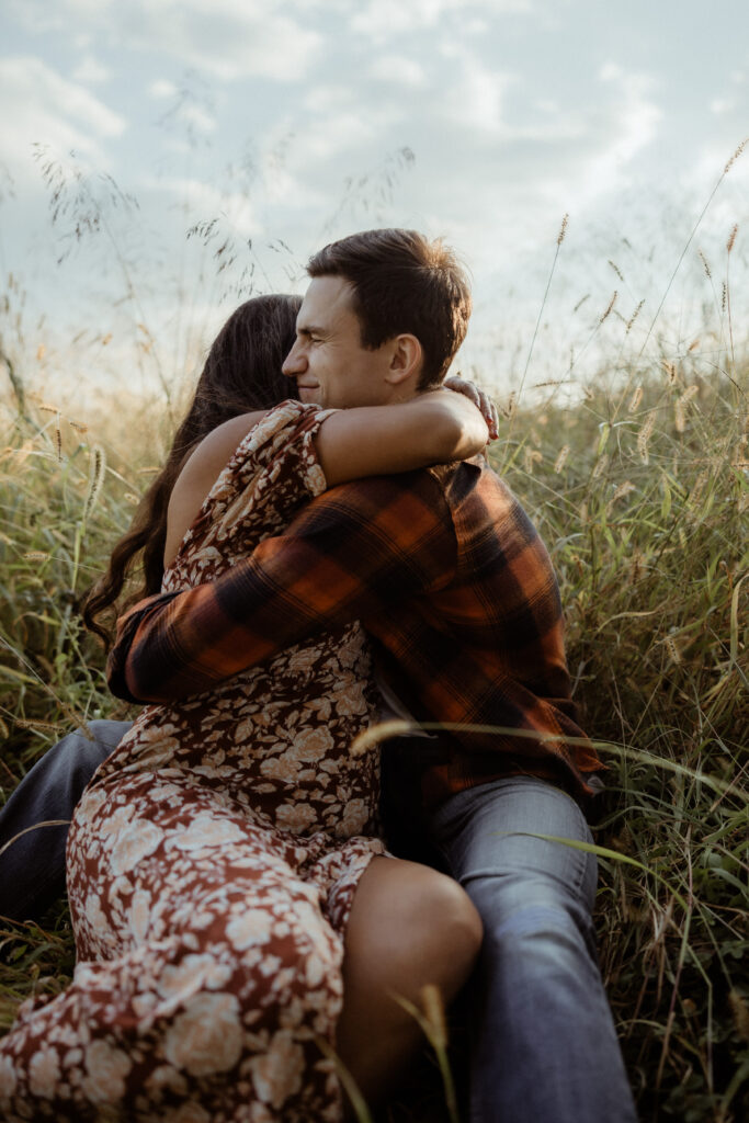 Stunning couple embrace in a field dreamy wild field