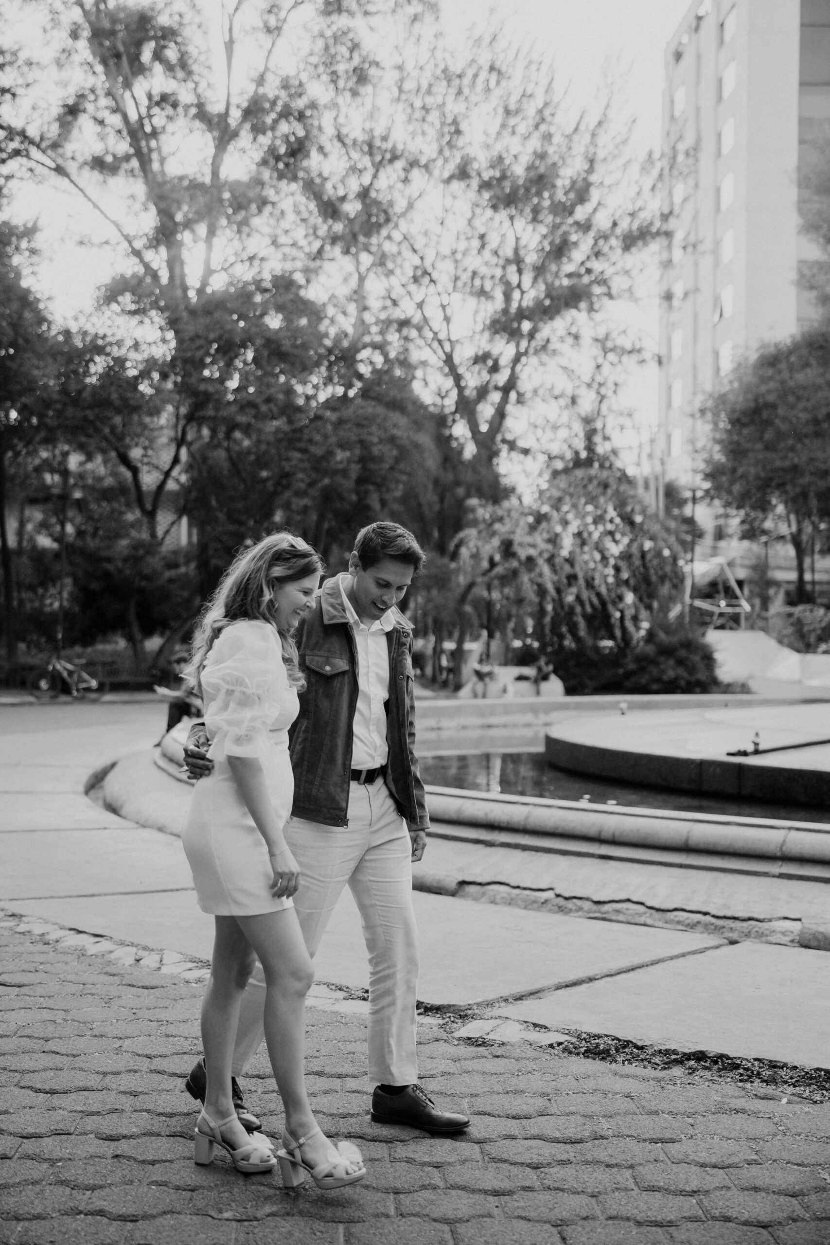 Beautiful couple walk in Plaza Rio de Janiero during their Mexico engagement