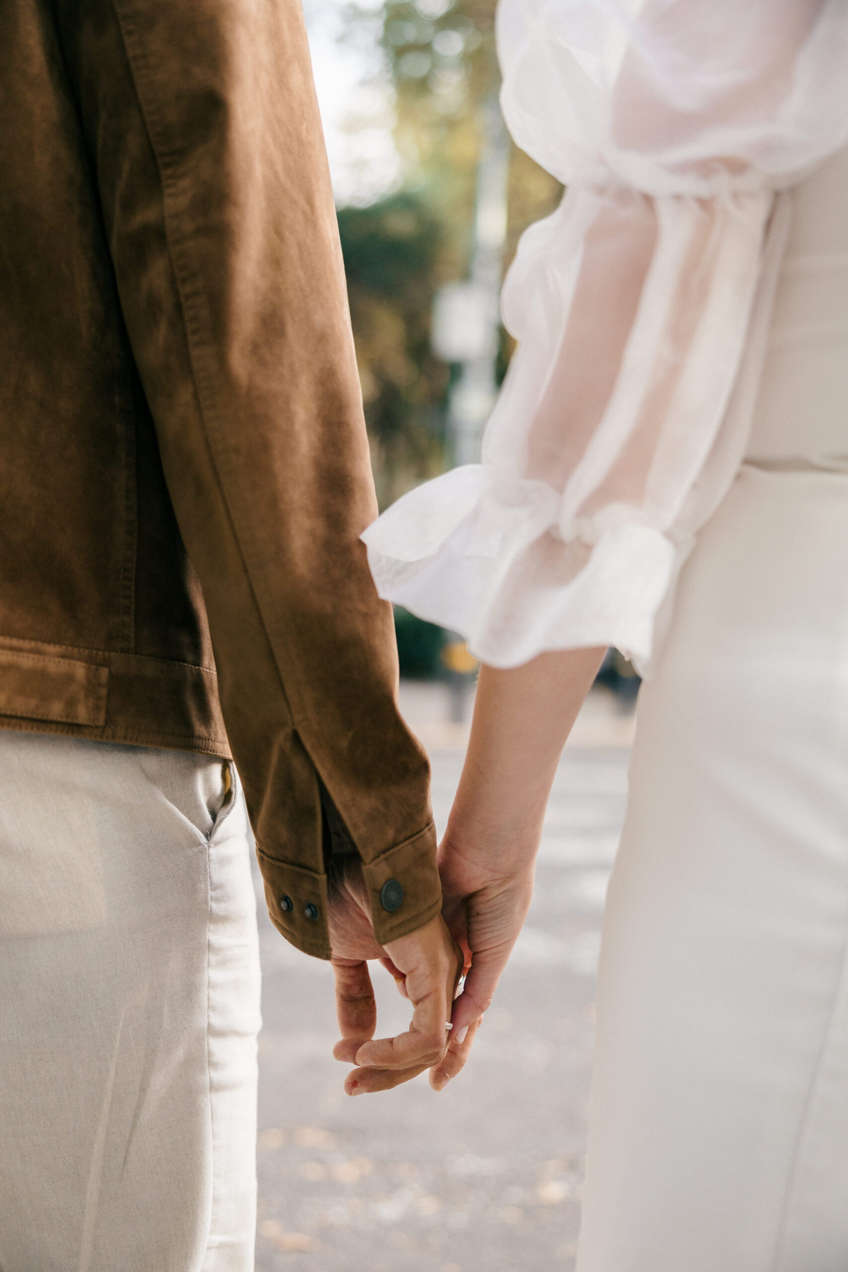 Stunning couple hold hands during their engagement photos
