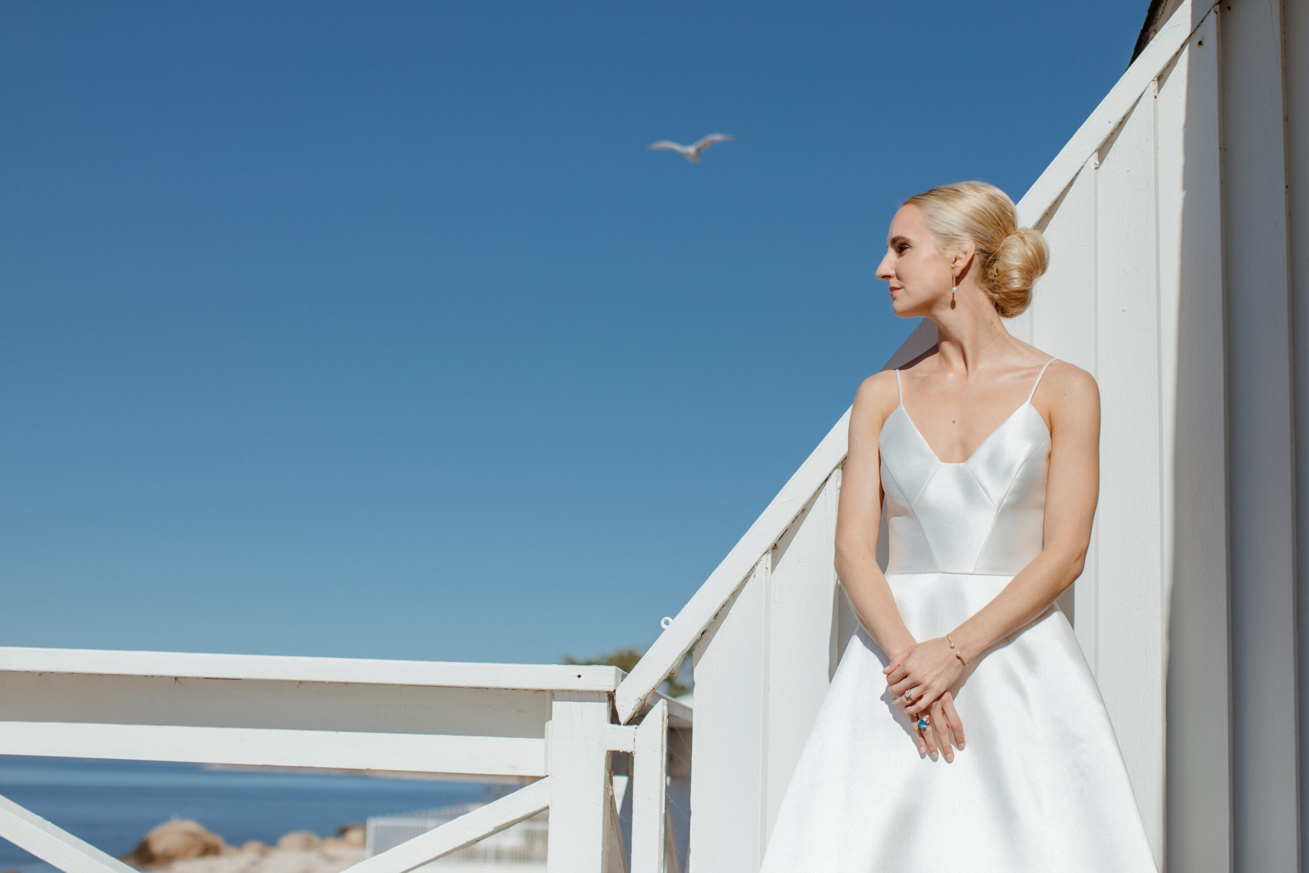A blonde bride in her modern bridal gown before her bedell cellars wedding