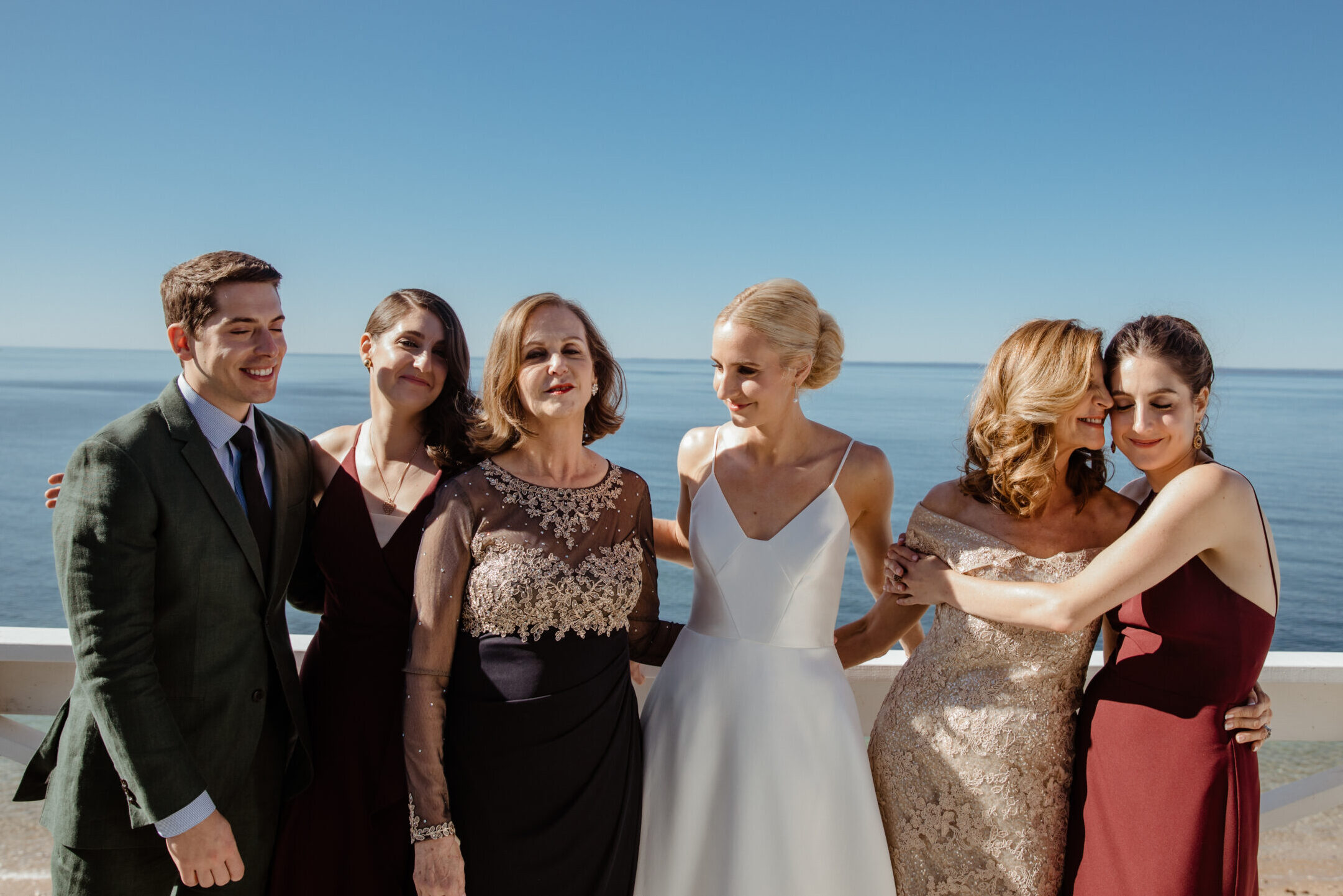 Bride poses with her friends before her dreamy Bedell Cellars wedding